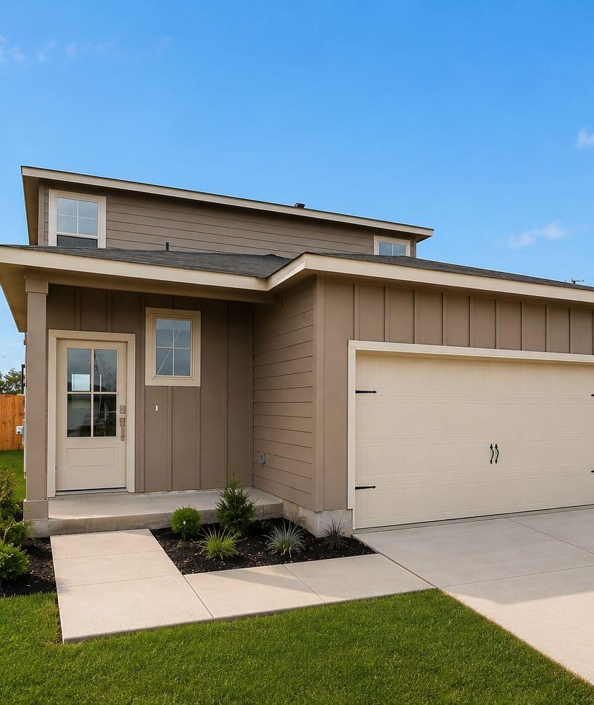 Modern home exterior at Agave in San Antonio, Texas by Davidson Homes with a two-car garage and landscaped front yard.