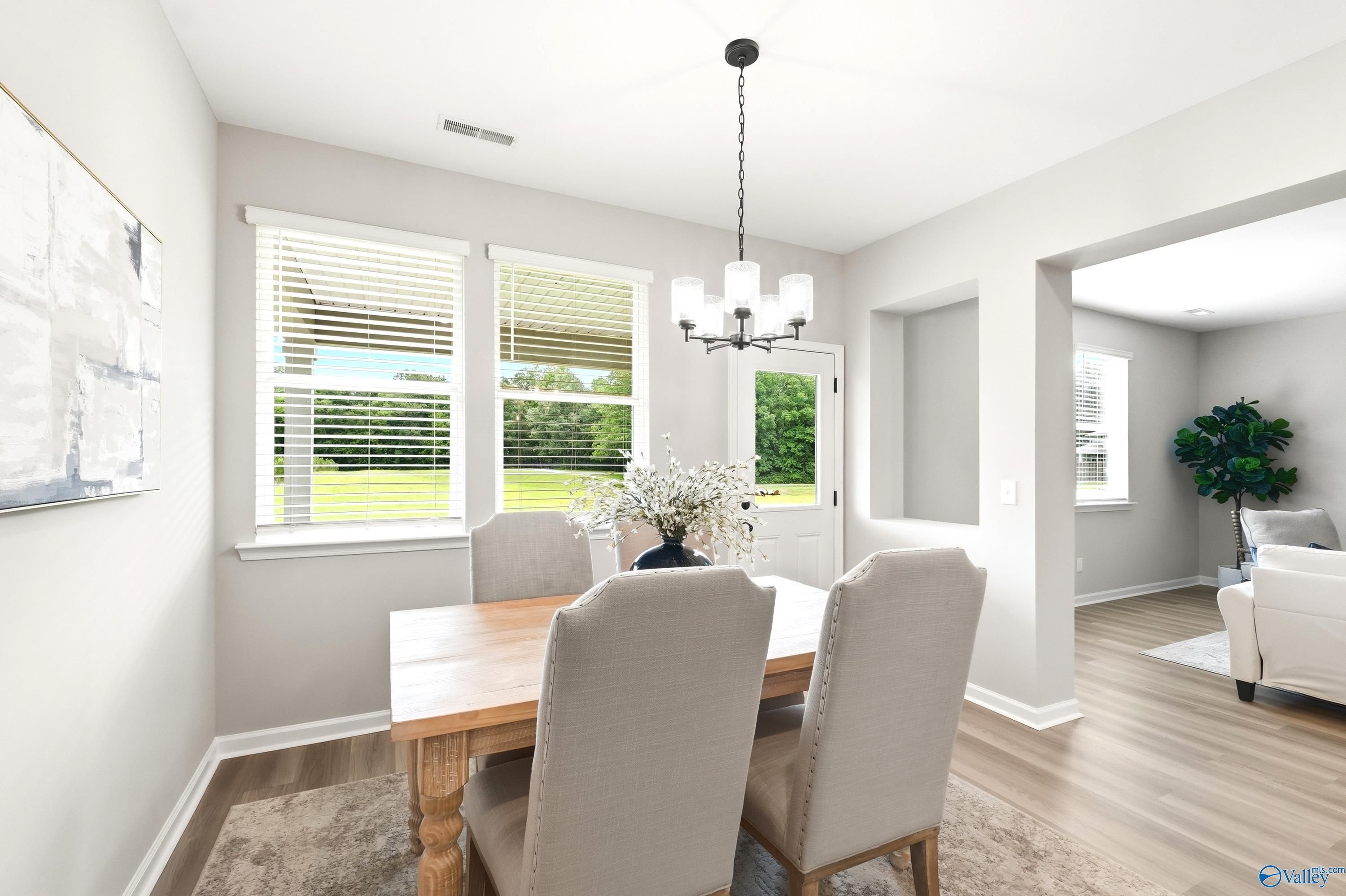 Bright dining area with wood table and upholstered chairs in The Dorado floor plan at Riverton Preserve, Huntsville, AL.