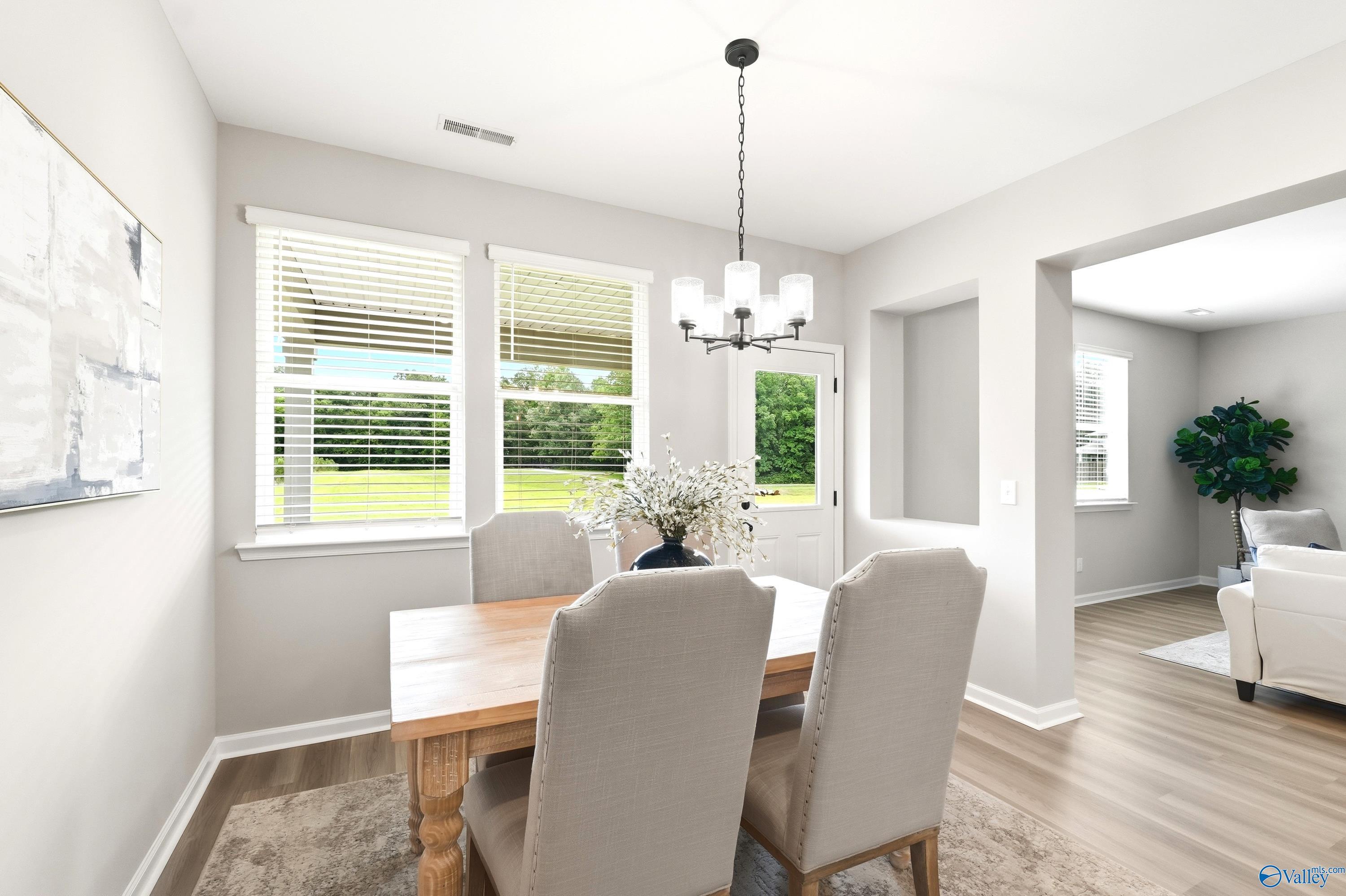 Bright dining area with wood table and upholstered chairs in The Dorado floor plan at Riverton Preserve, Huntsville, AL.