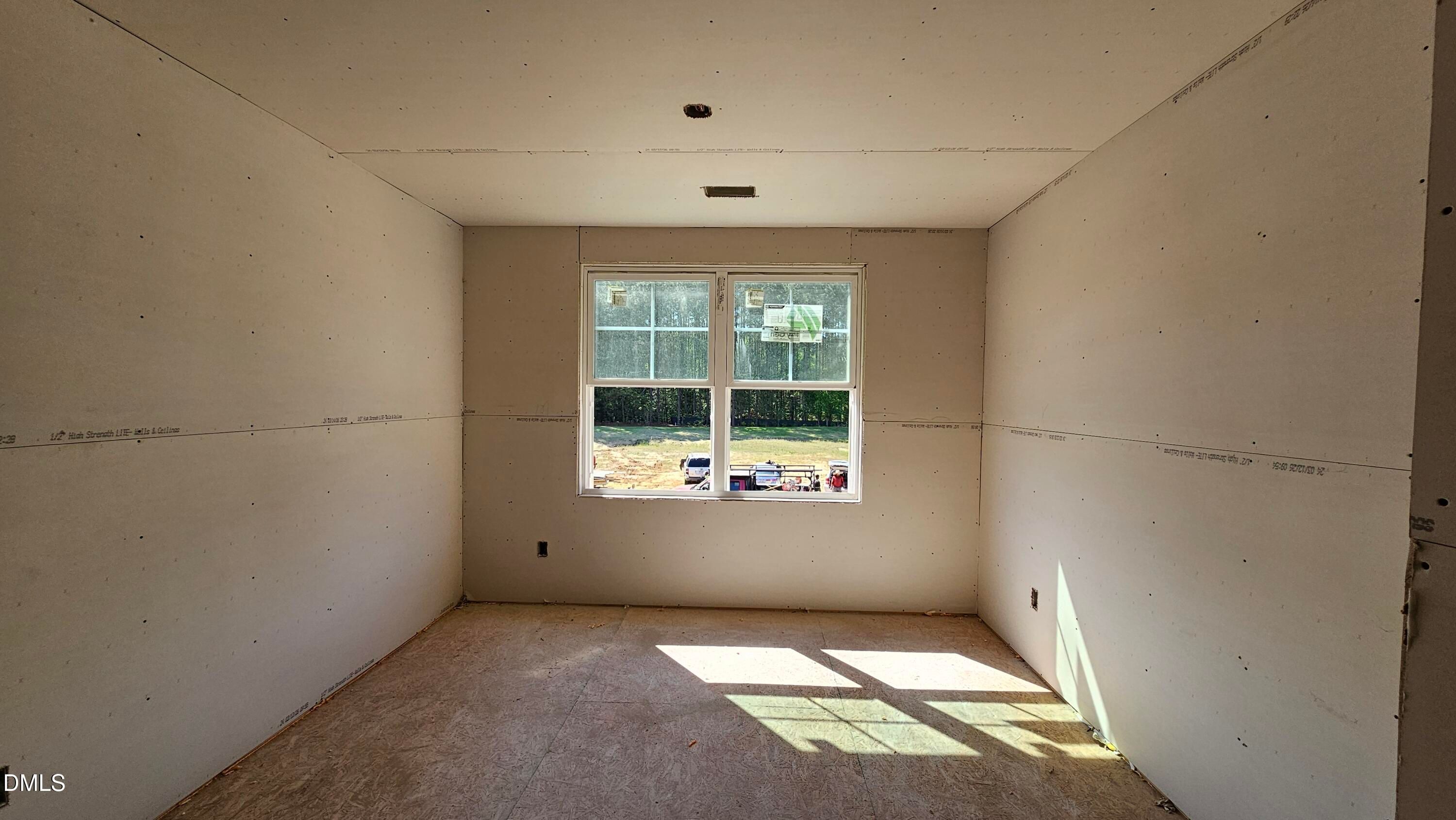 Unfinished bedroom with drywall and natural light in The Graham Interior floor plan at Springvale, Fuquay-Varina, NC.