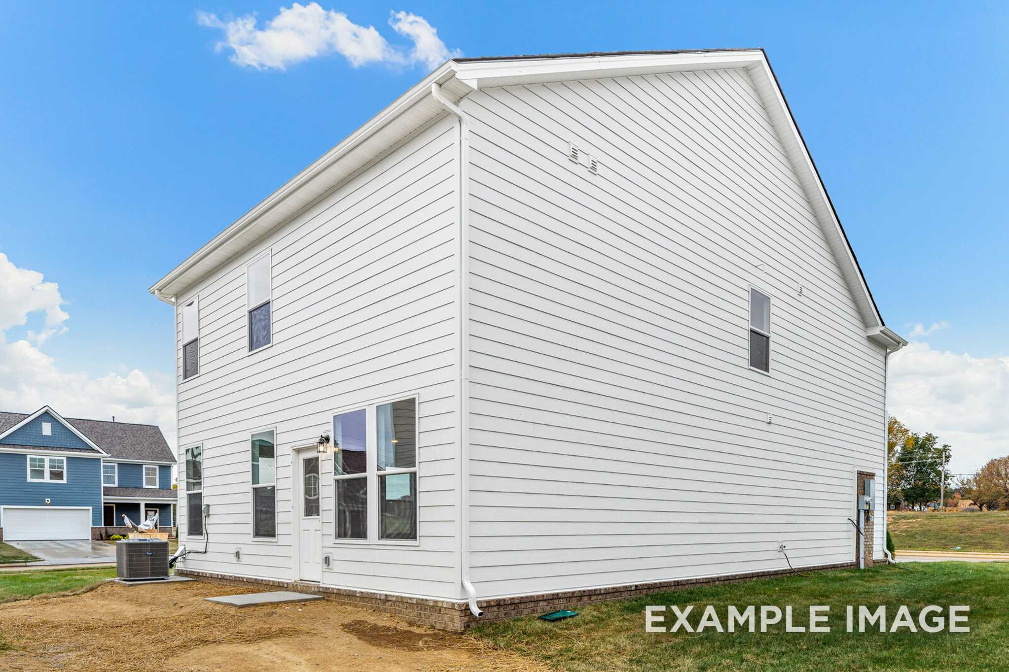 Side elevation of The Grayson A 2-story home with white vinyl siding, 2-car garage, and upper master suite in White House, TN