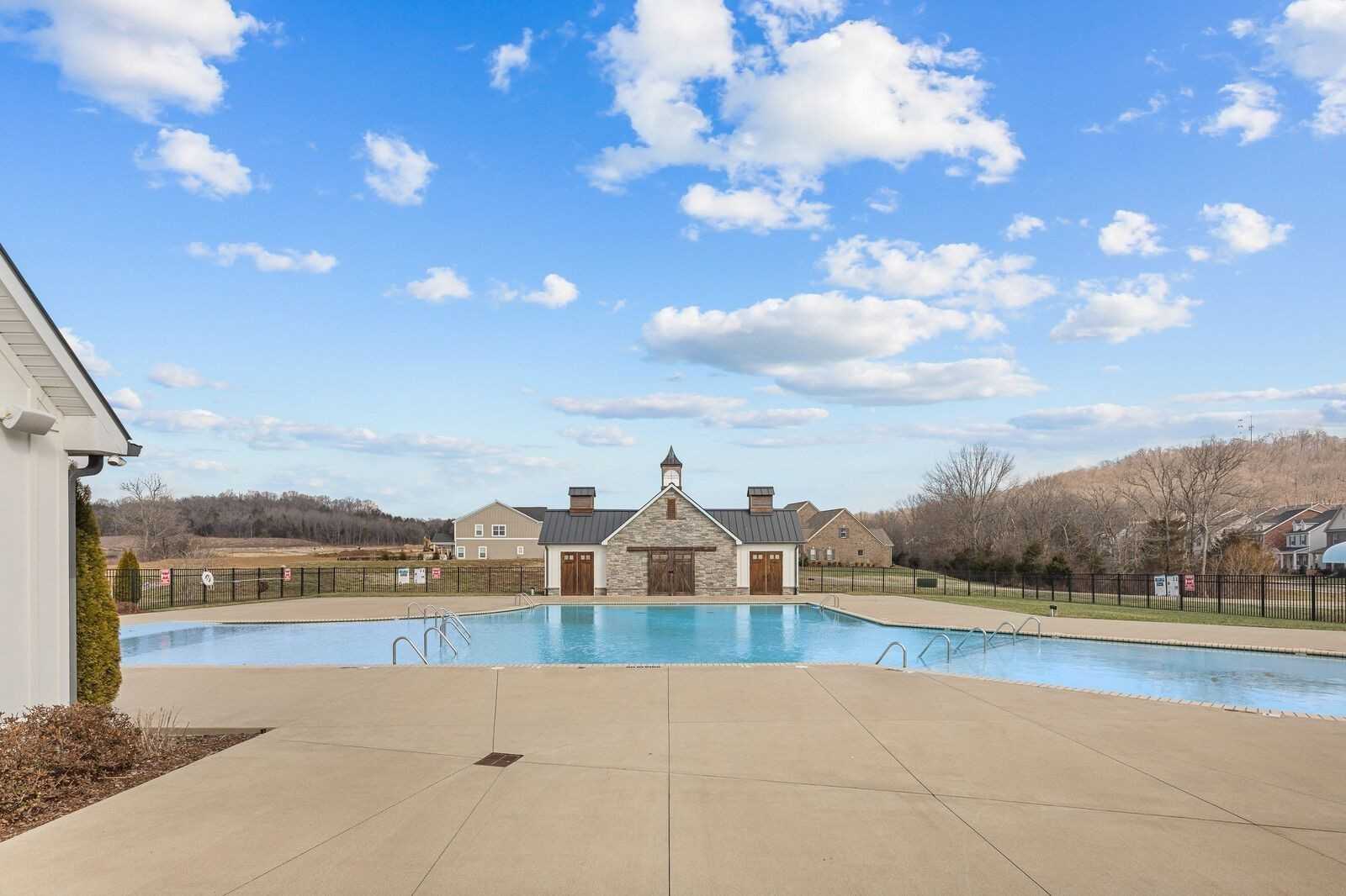 Inviting community pool with deck and clubhouse overlooking hills in Carellton, Gallatin, Tennessee