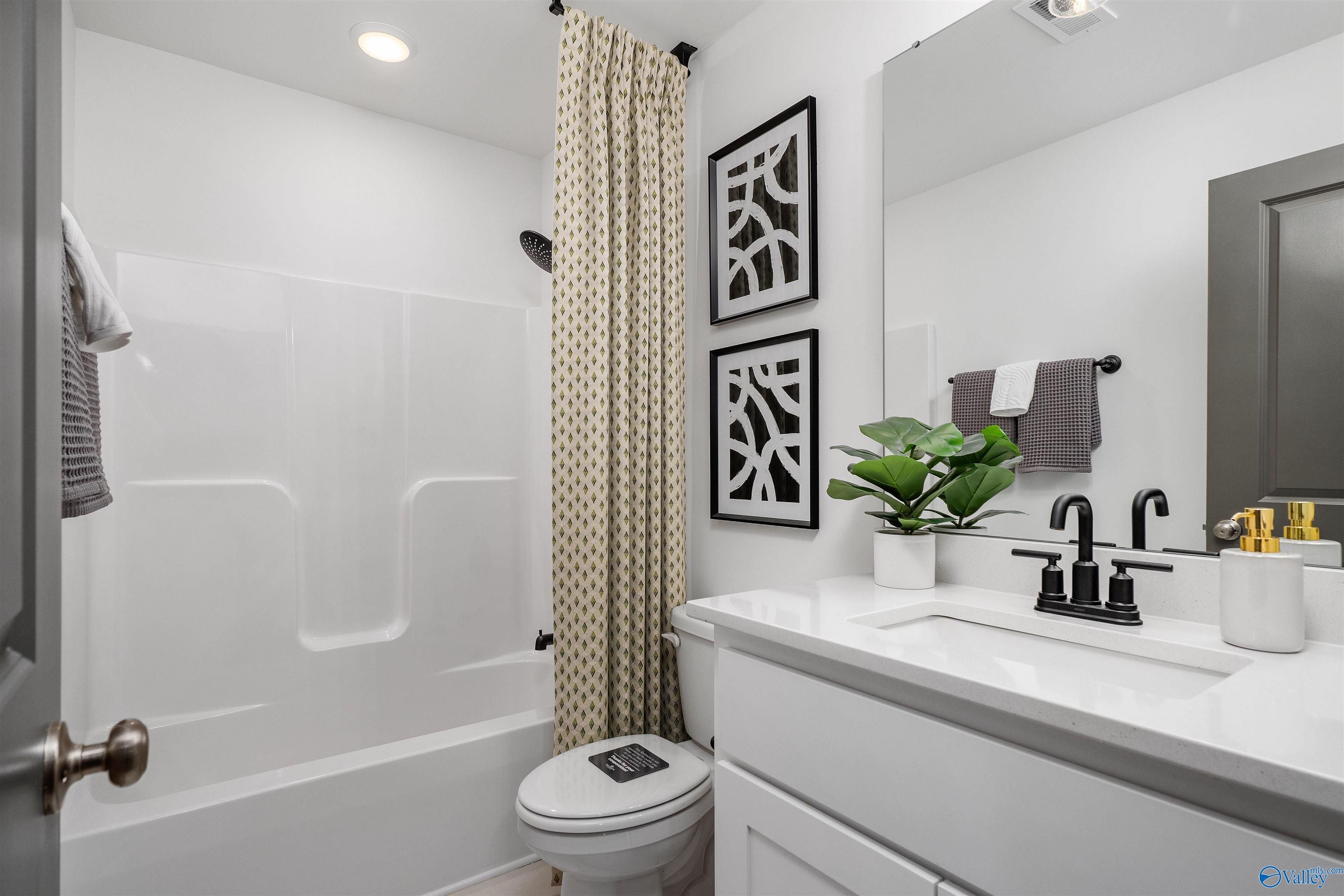Modern bathroom with white subway tile shower, soaking tub, and sleek vanity in Davidson Homes The Rockford B, Madison, AL