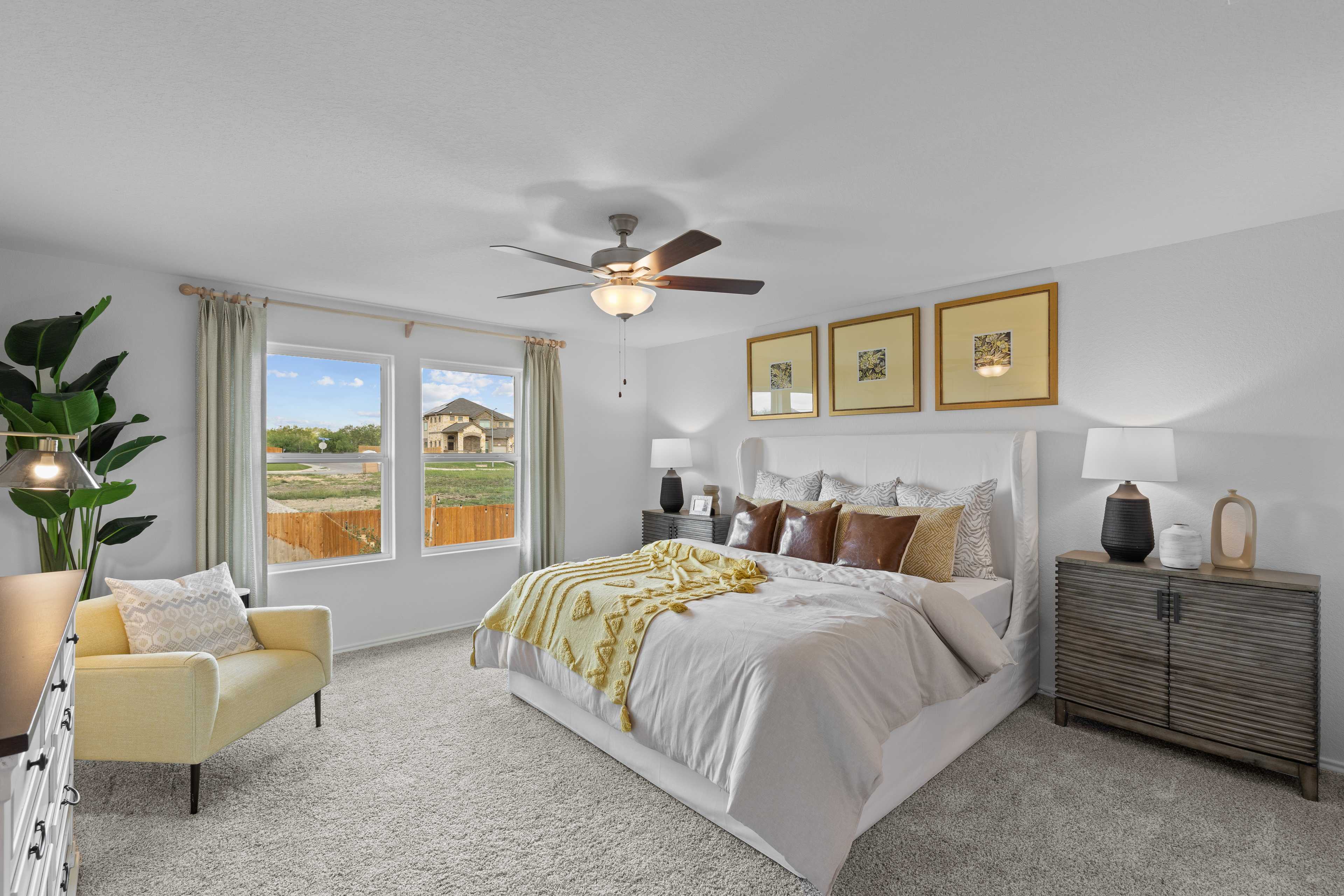 Spacious bedroom at Horizon Pointe in Converse Texas with king bed yellow accents ceiling fan and large windows
