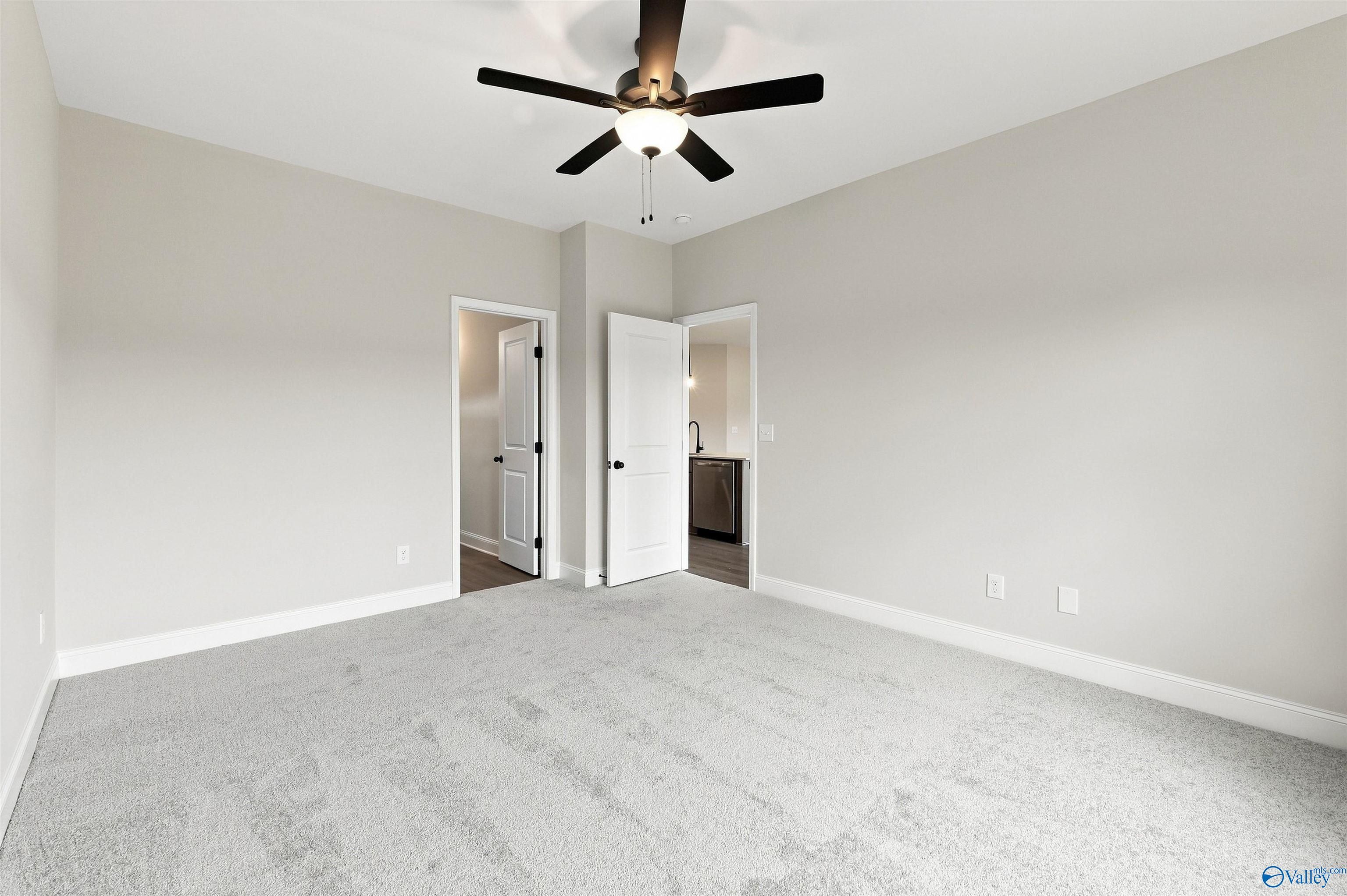 Spacious carpeted bedroom with ceiling fan in Davidson Homes Franklin C plan at The Meadows, Athens, Alabama