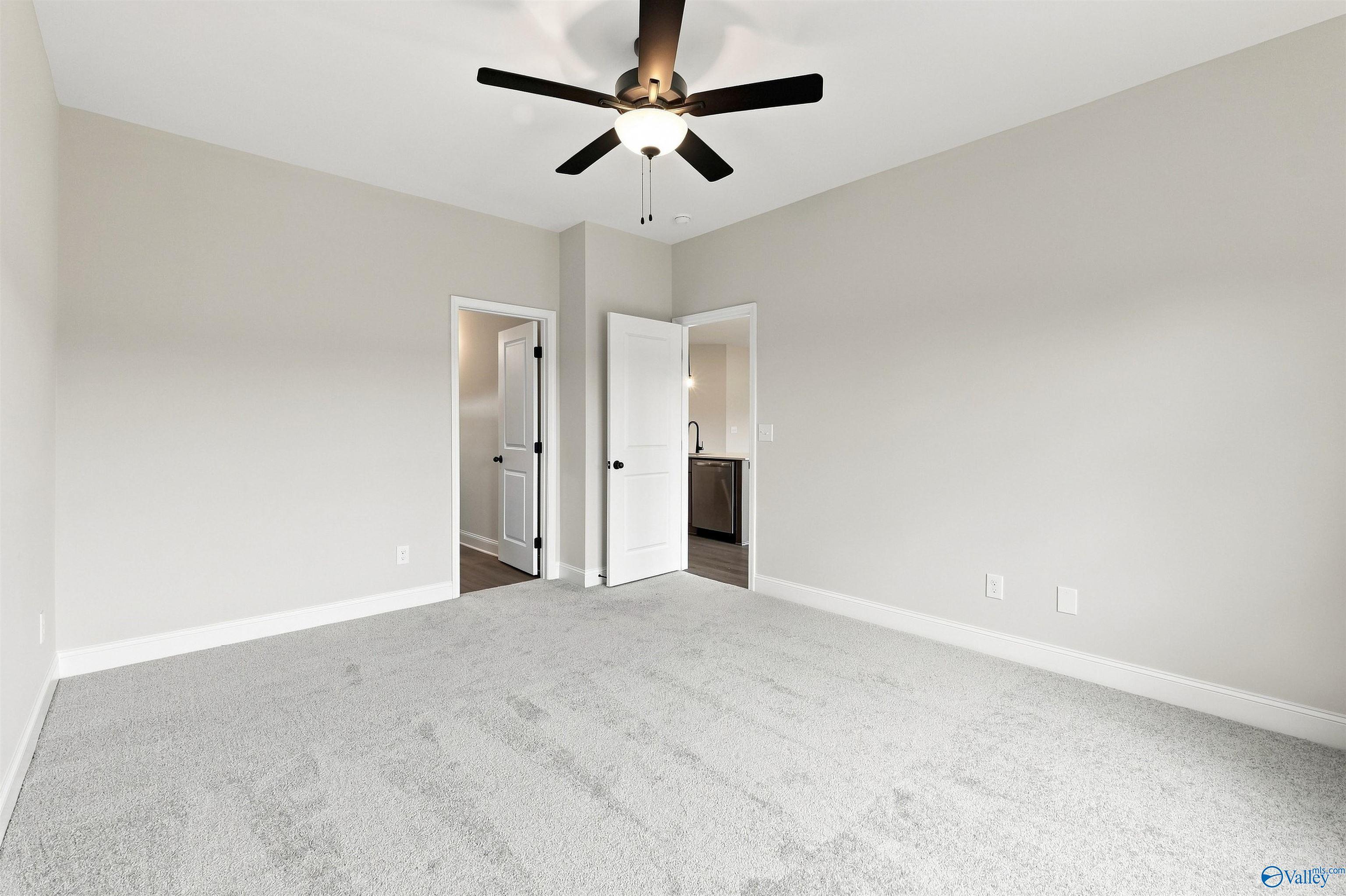 Spacious carpeted bedroom with ceiling fan in Davidson Homes Franklin C plan at The Meadows, Athens, Alabama