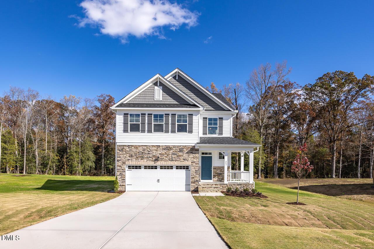 Modern two-story Gavin C home with white siding, stone garage, and front porch in Wellers Knoll, Lillington, North Carolina