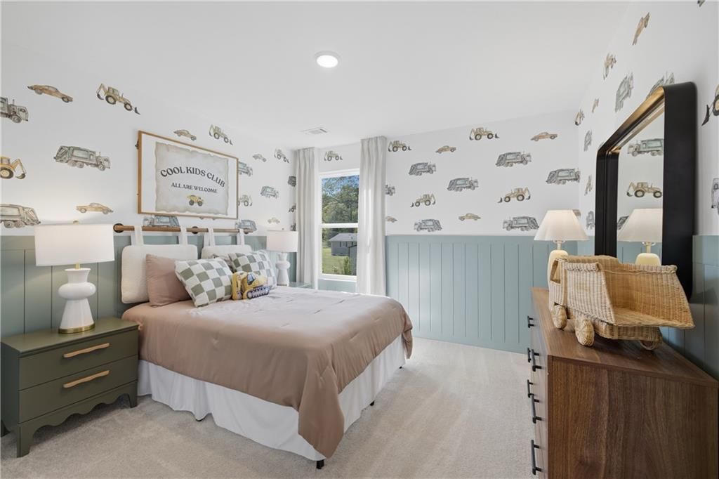 Cozy bedroom with vehicle wallpaper, wood-frame bed, and green nightstand in Davidson Homes The Sinclair B, Greene Farm, Cartersville, Georgia