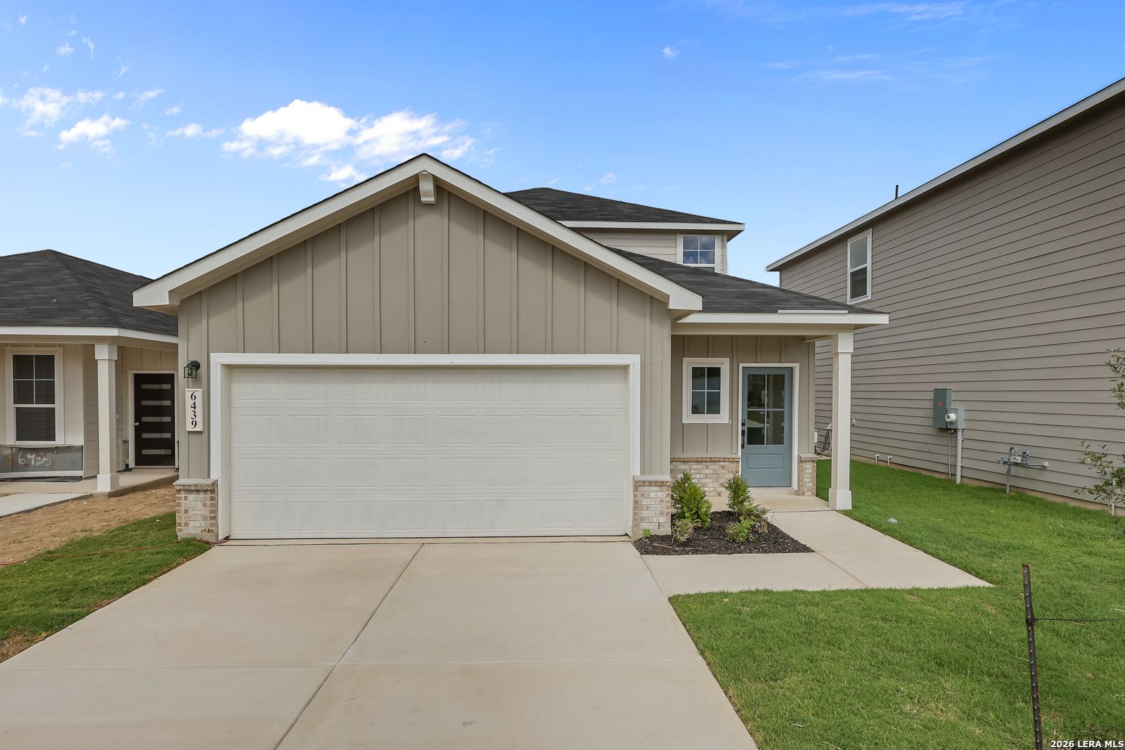 Front exterior of Davidson Homes The Summit B with 2-car garage and covered porch in Morgan Meadows, San Antonio, Texas