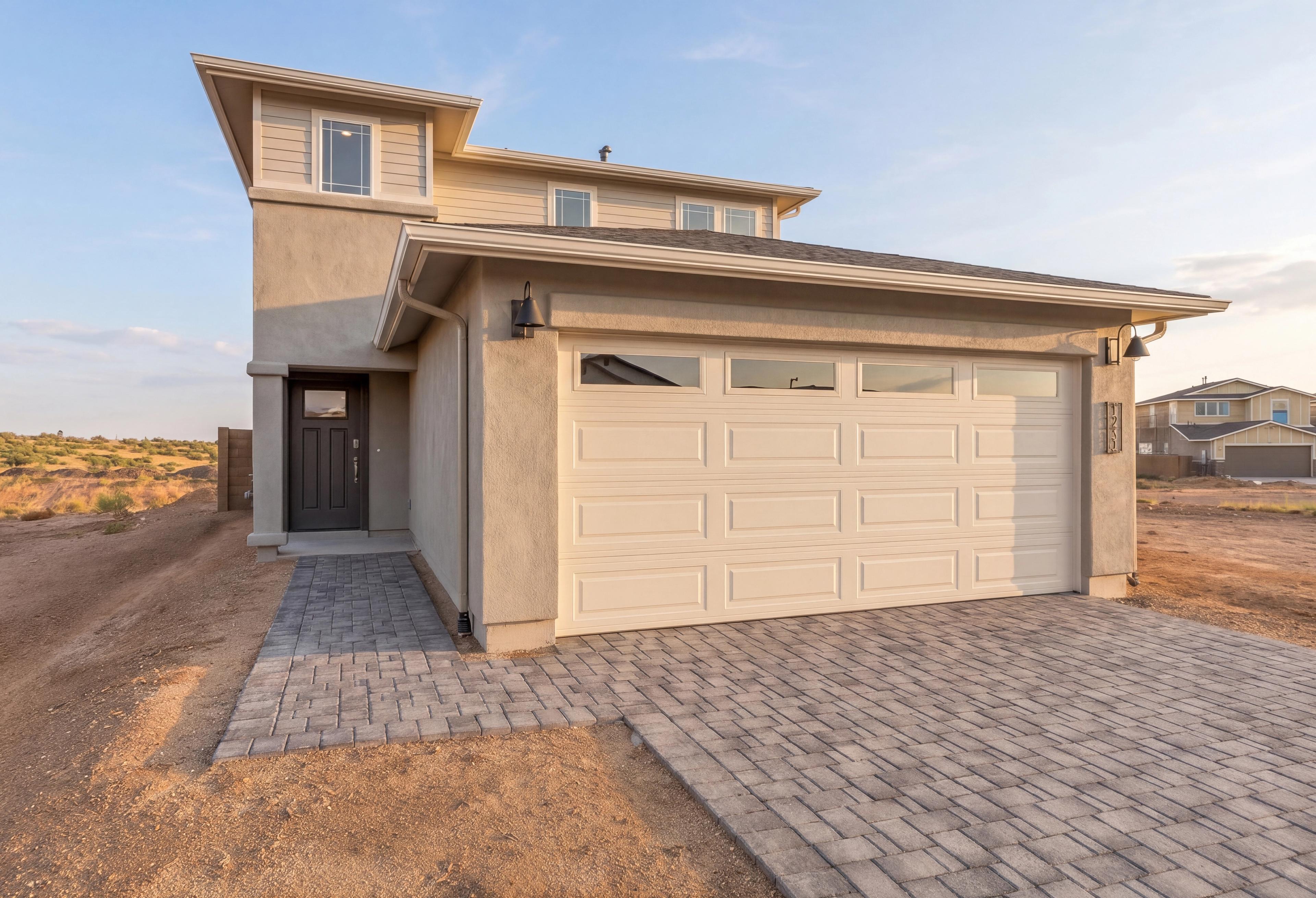 Two-story stucco exterior of The Raleigh by Davidson Homes with 3-car garage and paver driveway in Prescott, Arizona