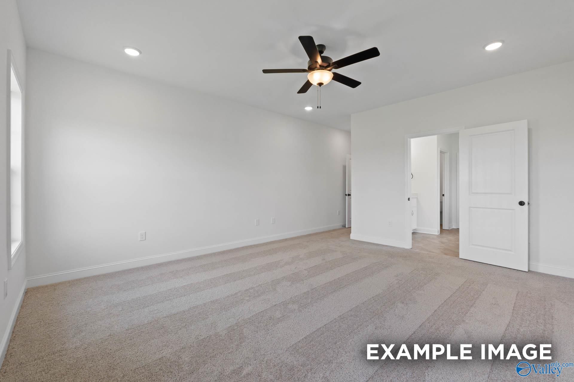 Spacious, neutral-toned bedroom with ceiling fan in The Rockford B floor plan by Davidson Homes in Briercreek, Meridianville.