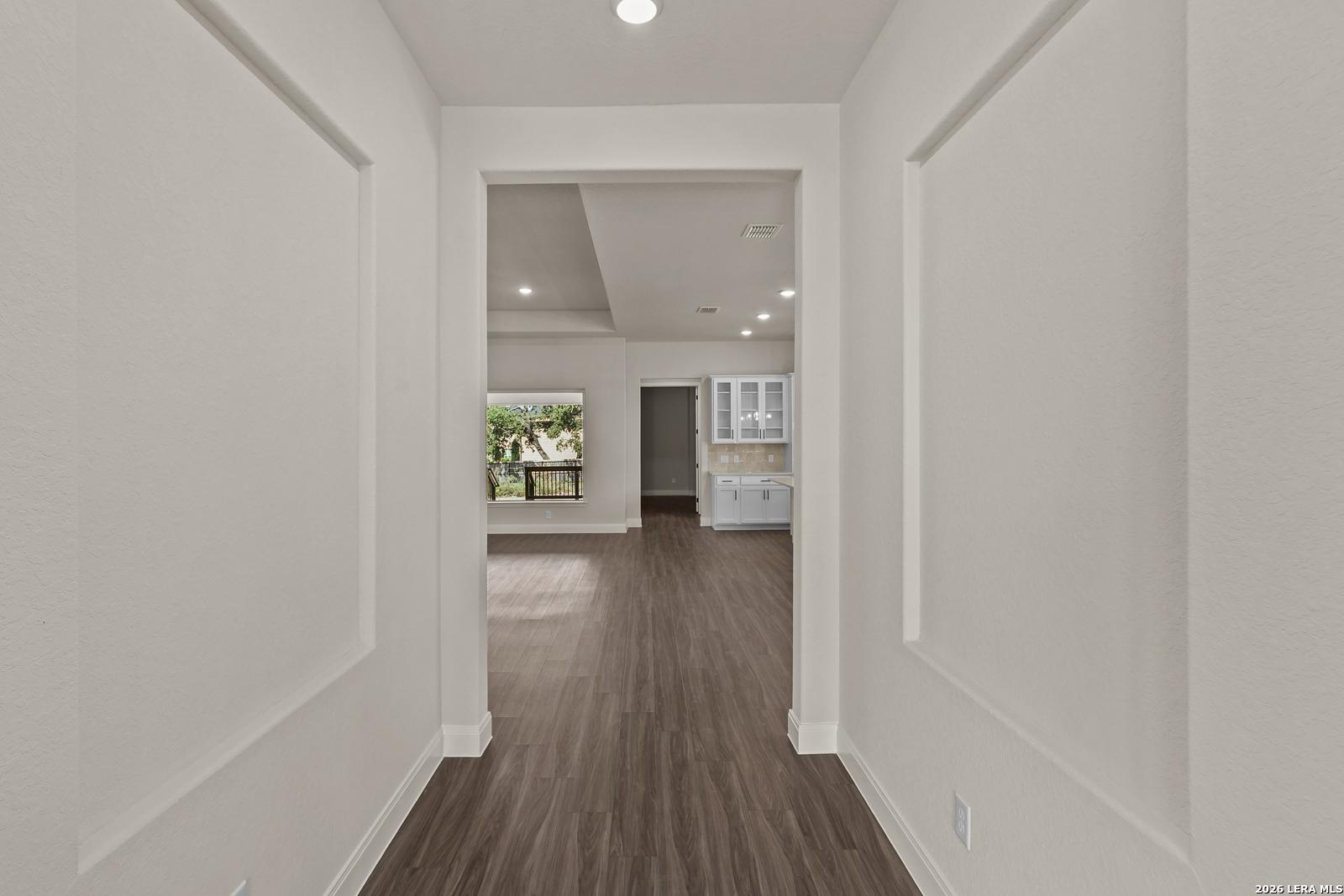 Bright entryway leading to an open-concept kitchen and living area in The Summerlin B floor plan, Potranco Oaks, Castroville.