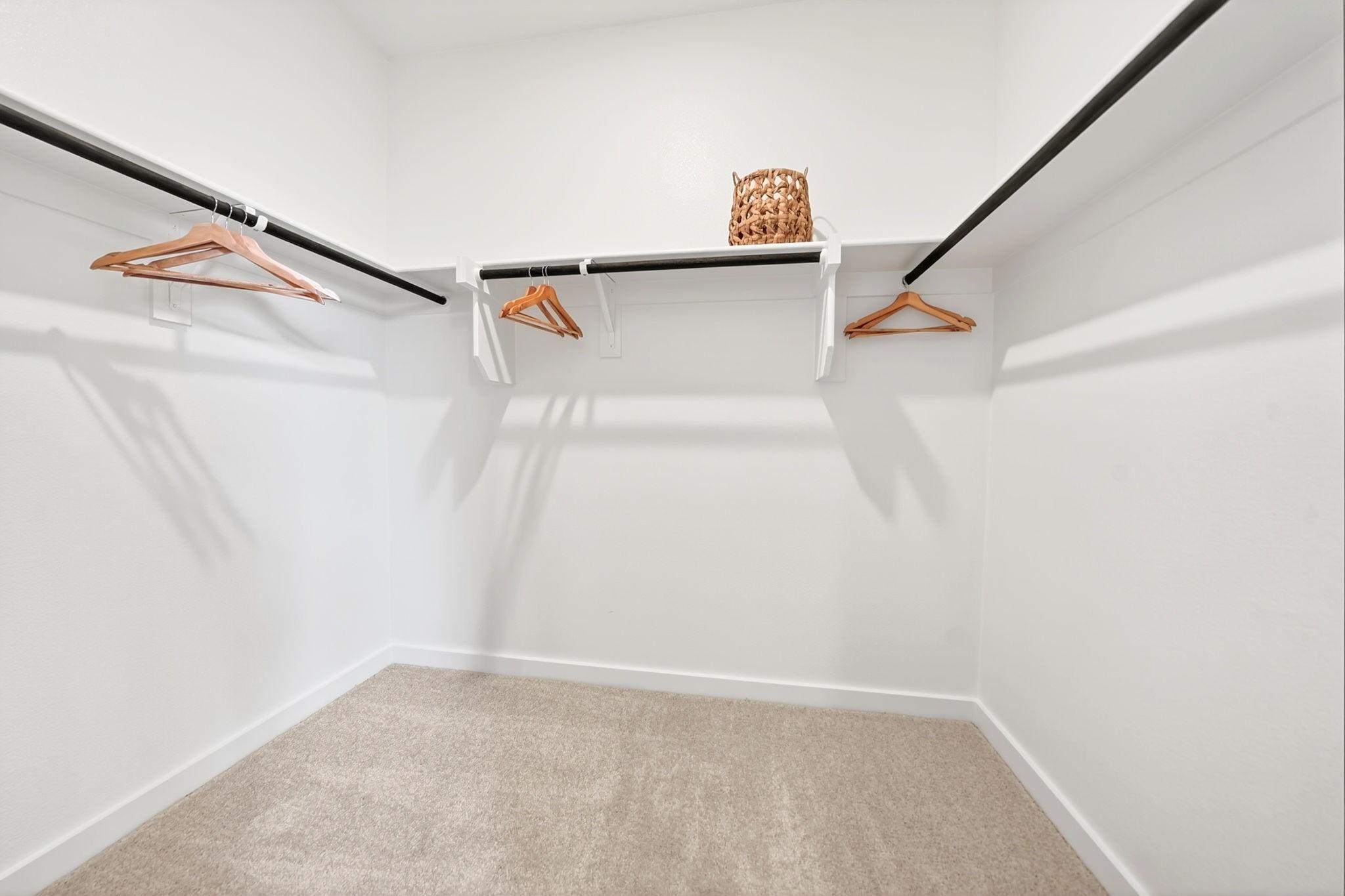 Spacious walk-in closet with shelving in The Laurel M floor plan at Parks at Foster Crossing in Anna, Texas.