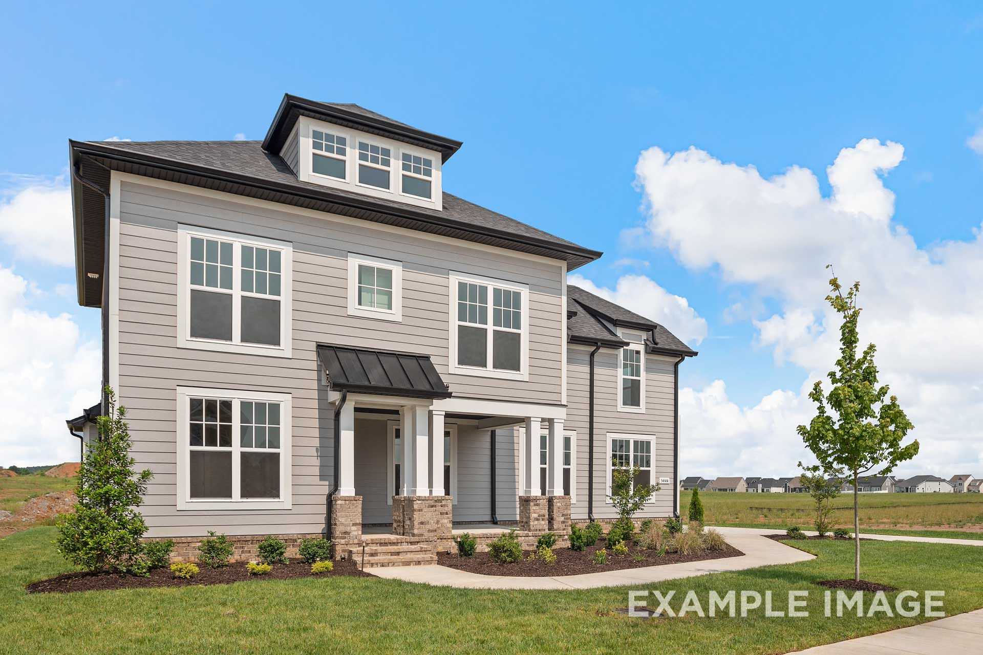 Two-story The Hathaway exterior by Davidson Homes in Murfreesboro TN, gray siding, black roof, covered porch, 3-car garage, landscaped yard