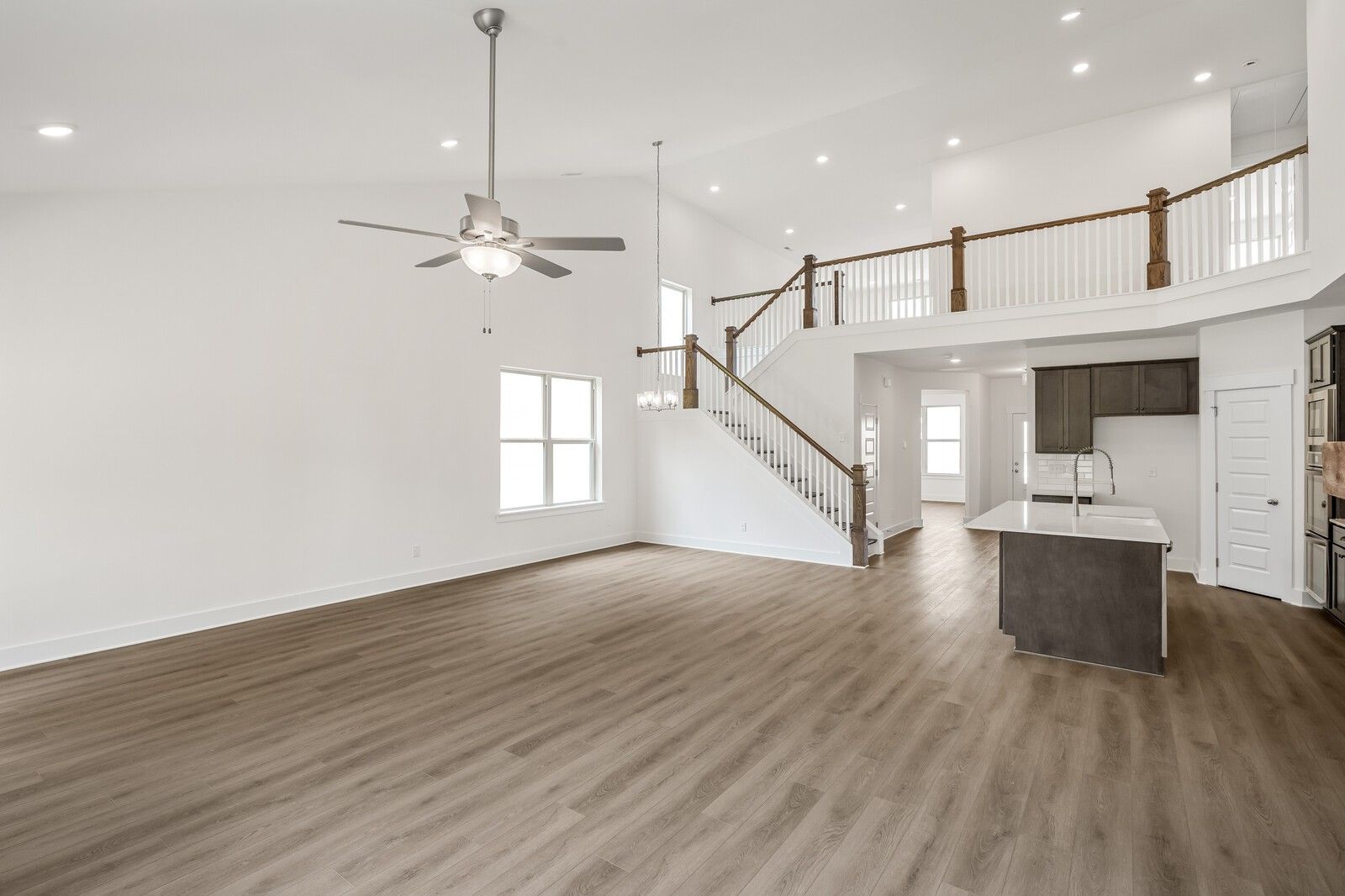 Open-concept living room with vaulted ceilings and mezzanine in The Ridgeport C floor plan, Woods Crossing, Gallatin, TN.