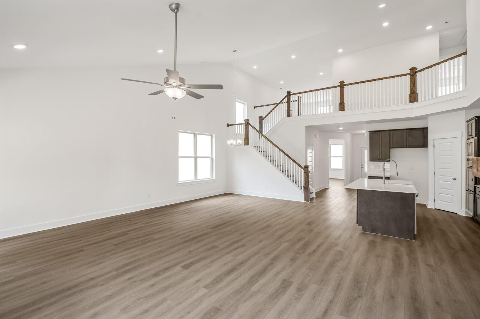 Open-concept living room with vaulted ceilings and mezzanine in The Ridgeport C floor plan, Woods Crossing, Gallatin, TN.