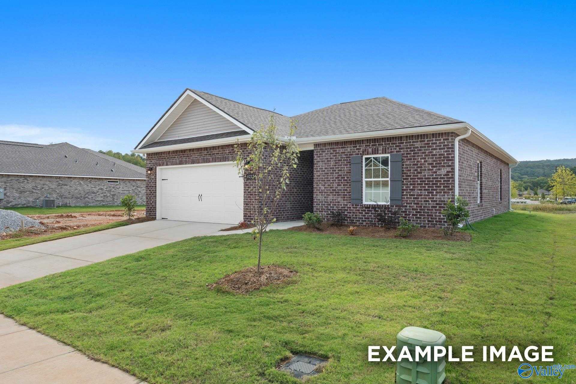 Single-story brick home with 2-car garage and landscaped yard, Davidson Homes The Butler in Ramsay Cove, Owens Cross Roads, Alabama