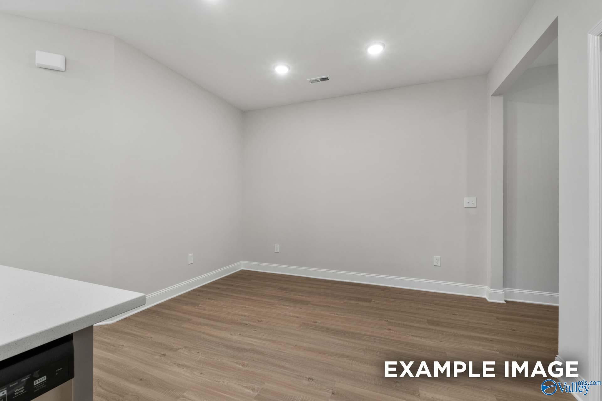 Empty bedroom with light gray walls, hardwood floors, and recessed lighting in Davidson Homes The Camilla B, Hartselle, AL