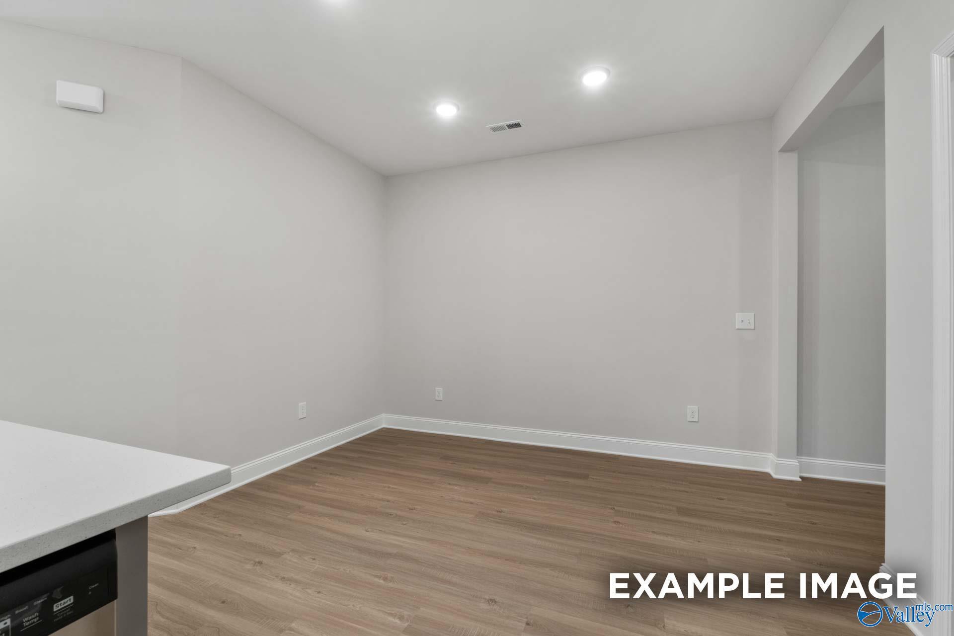 Empty bedroom with light gray walls, hardwood floors, and recessed lighting in Davidson Homes The Camilla B, Hartselle, AL