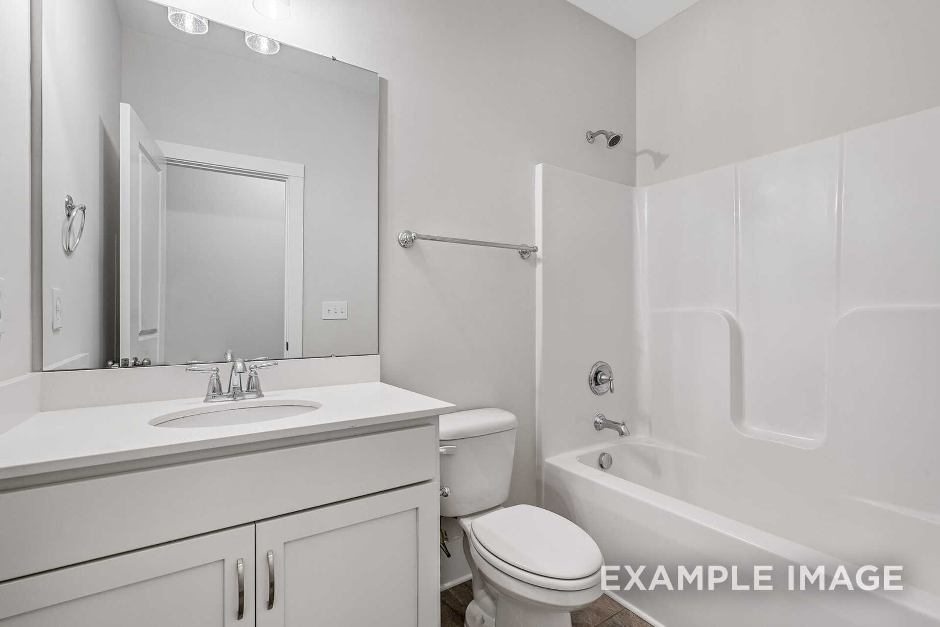 Spacious secondary bathroom in The Rockford by Davidson Homes, San Antonio: white vanity sink, tub shower combo, neutral gray walls