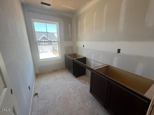 Unfinished laundry room with dark cabinetry in The Gavin C floor plan at Gregory Village, Lillington, North Carolina.