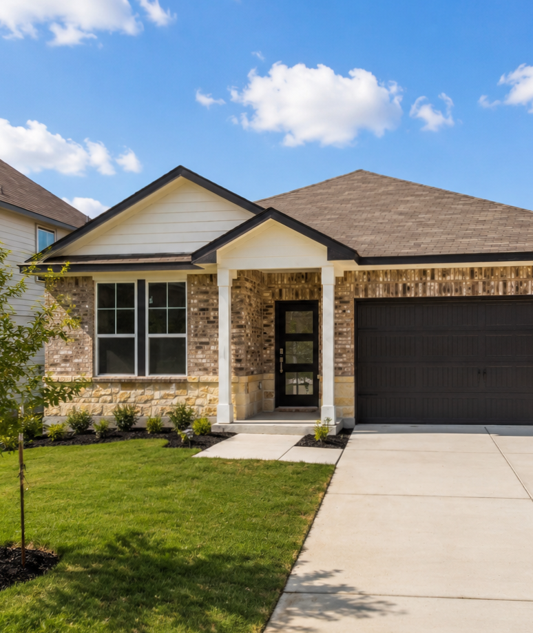 Single-story brick and stone home exterior by Davidson Homes at Saddle Creek Ranch in Cibolo, Texas with a two-car garage.