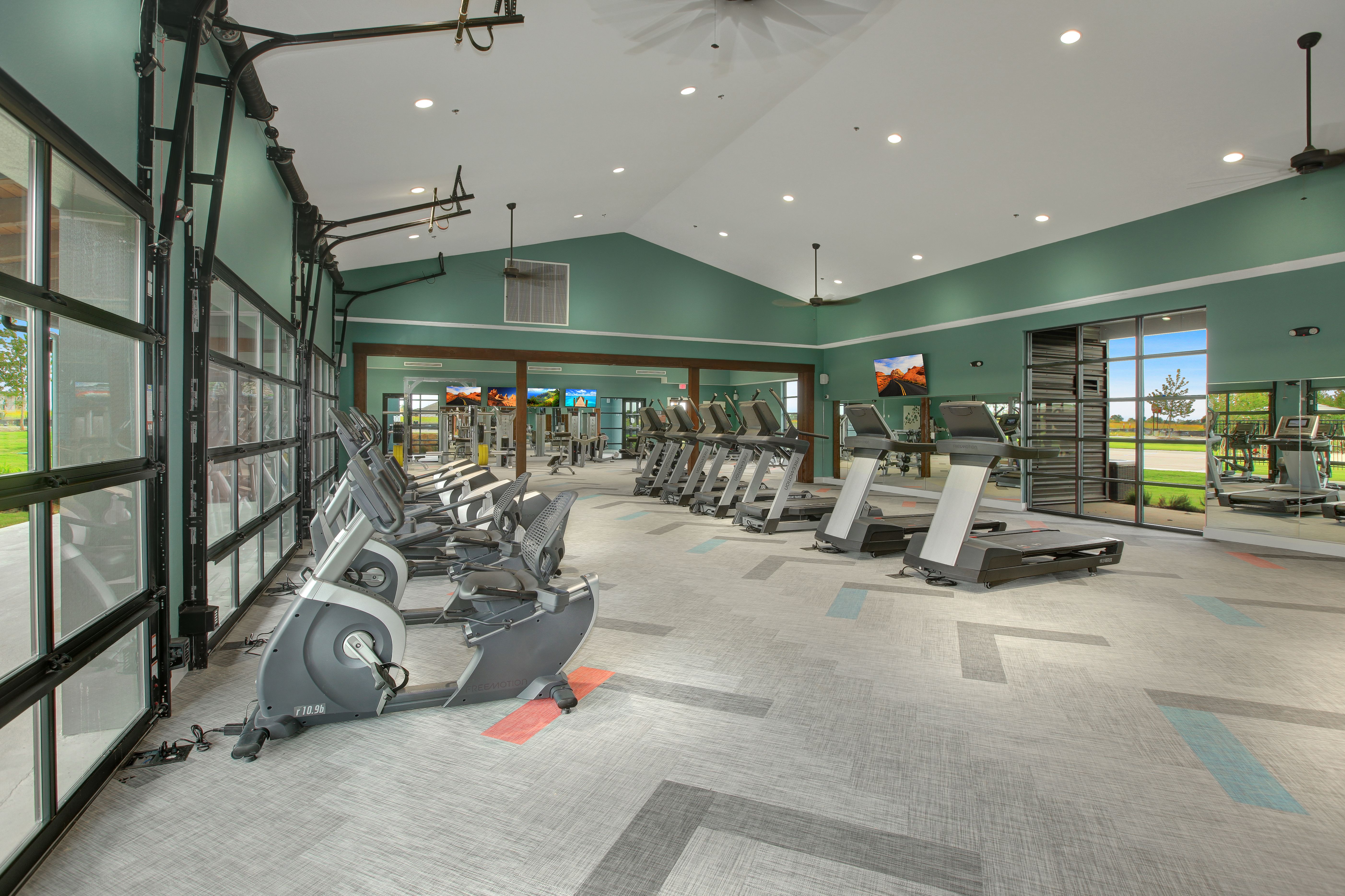 Onsite workout gym with treadmills, weight machines and televisions