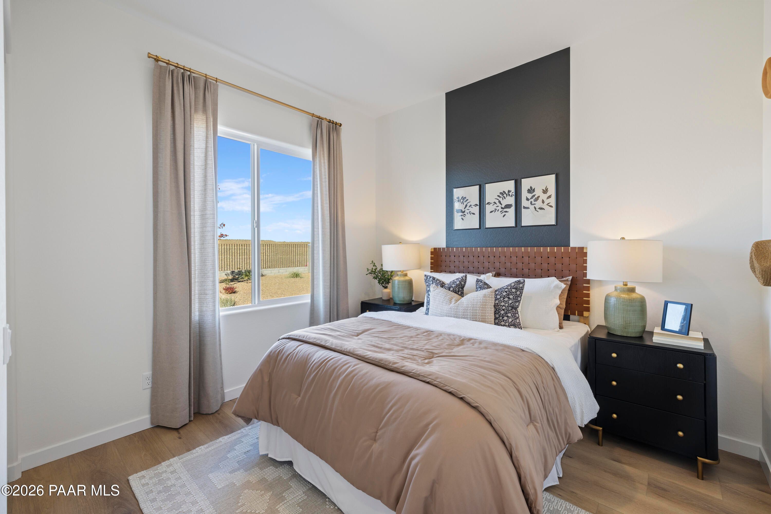 Modern bedroom with leather headboard and desert views in The Blaze D floor plan at Hidden Hills, Prescott, Arizona.