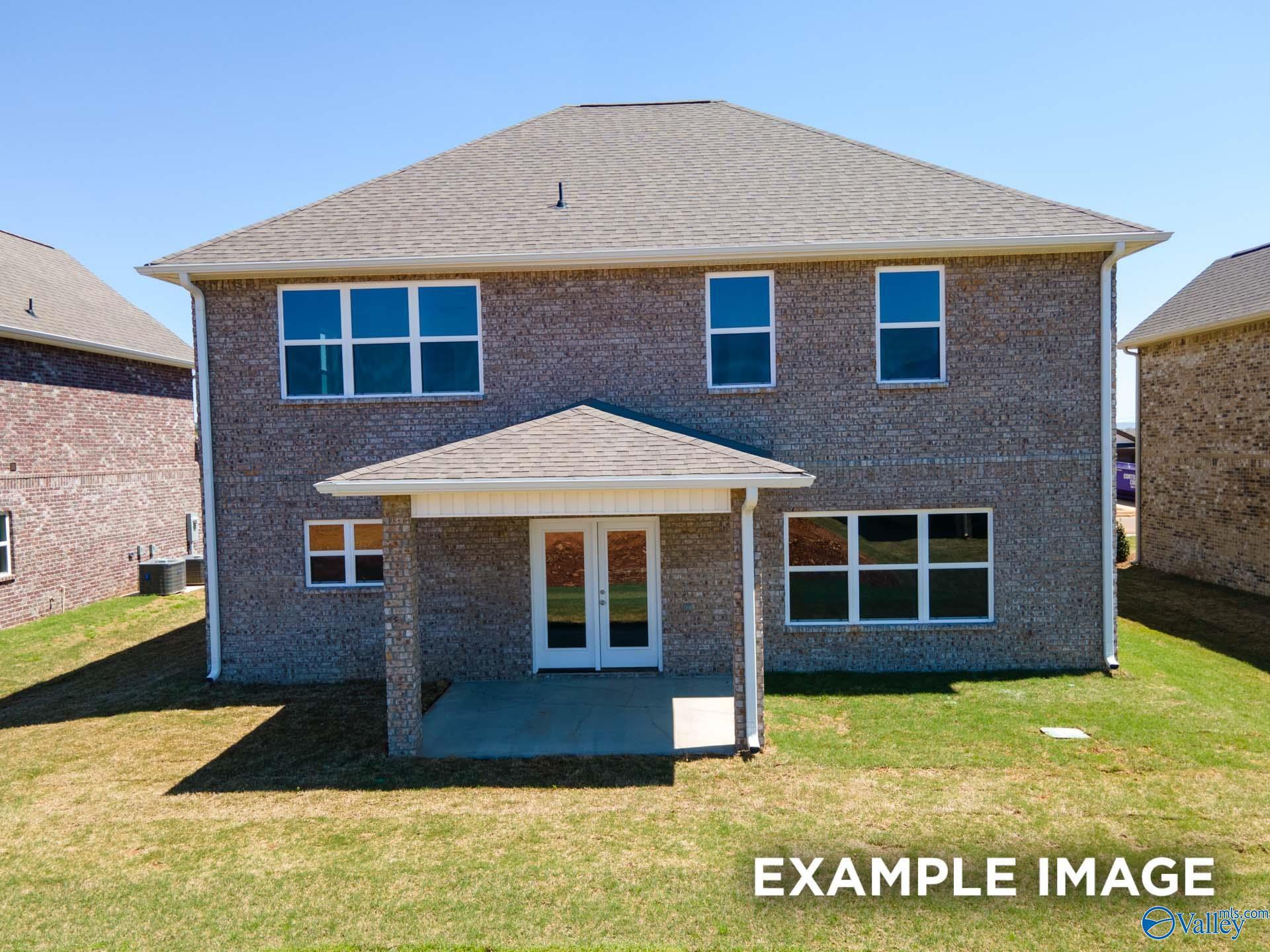 Rear exterior view of The Chelsea C by Davidson Homes featuring a covered back patio in Creek Grove, New Market, Alabama.