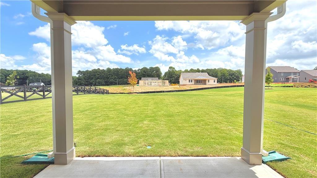 Covered back patio view overlooking a large private backyard in Wehunt Meadows, Hoschton, Georgia by Davidson Homes.