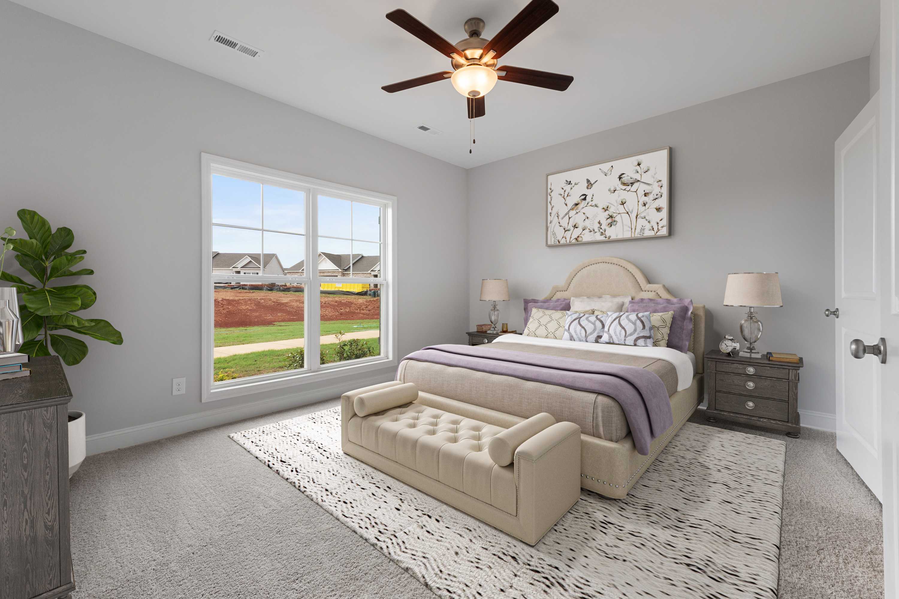 Serene master bedroom at The Villas at Barnett's Crossing in Madison, Alabama with tufted bed, large window overlooking neighborhood, and modern gray decor