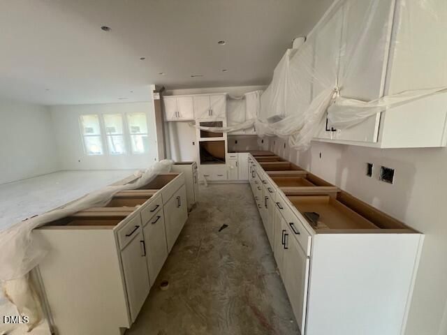 Kitchen under construction with white cabinets and center island in new Davidson Homes Magnolia II B plan, Lillington NC