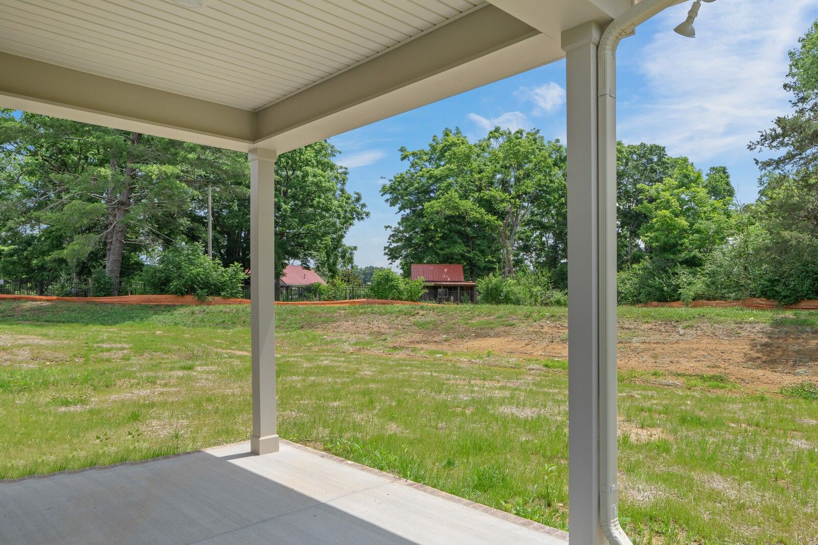 Covered patio view of a large backyard in Woods Crossing, Gallatin, TN, featuring The Ridgeport C floor plan.