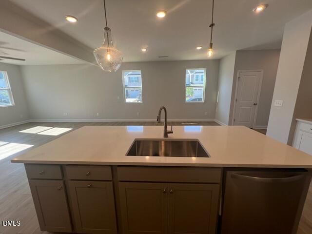 Spacious open-concept kitchen with quartz island, stainless sink, gray cabinets in Davidson Homes Adalynn B, Lillington NC