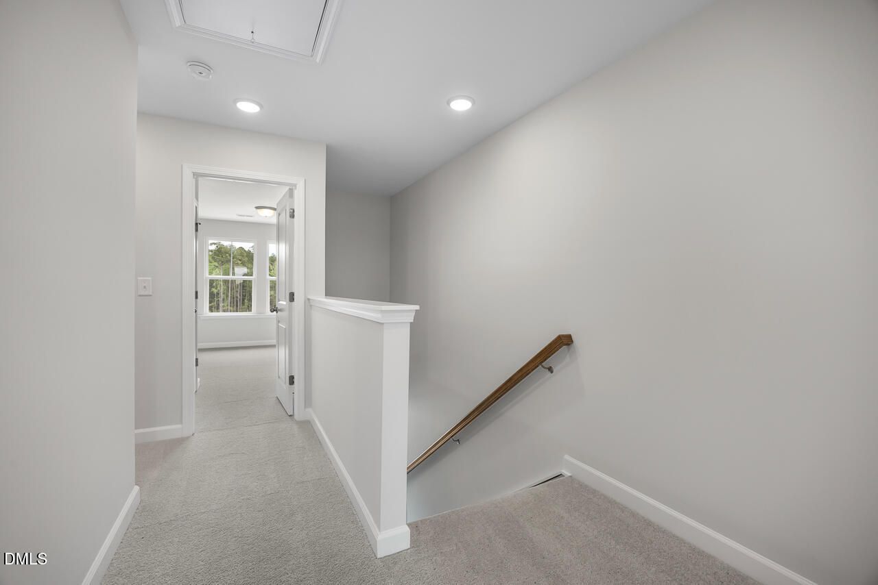 Bright upper-level landing and staircase in The Mitchell Interior floor plan at Forestville Yard Townhomes in Knightdale, NC.