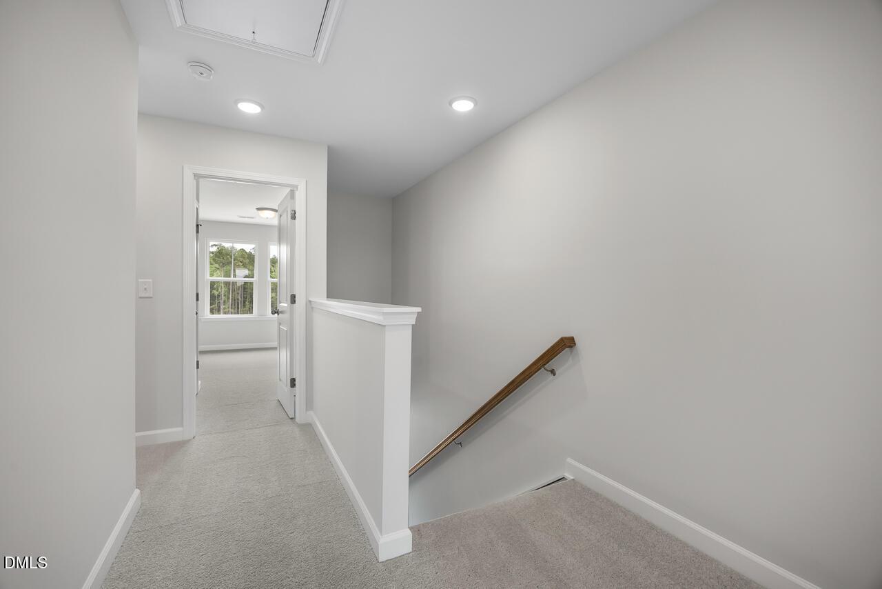 Bright upper-level landing and staircase in The Mitchell Interior floor plan at Forestville Yard Townhomes in Knightdale, NC.
