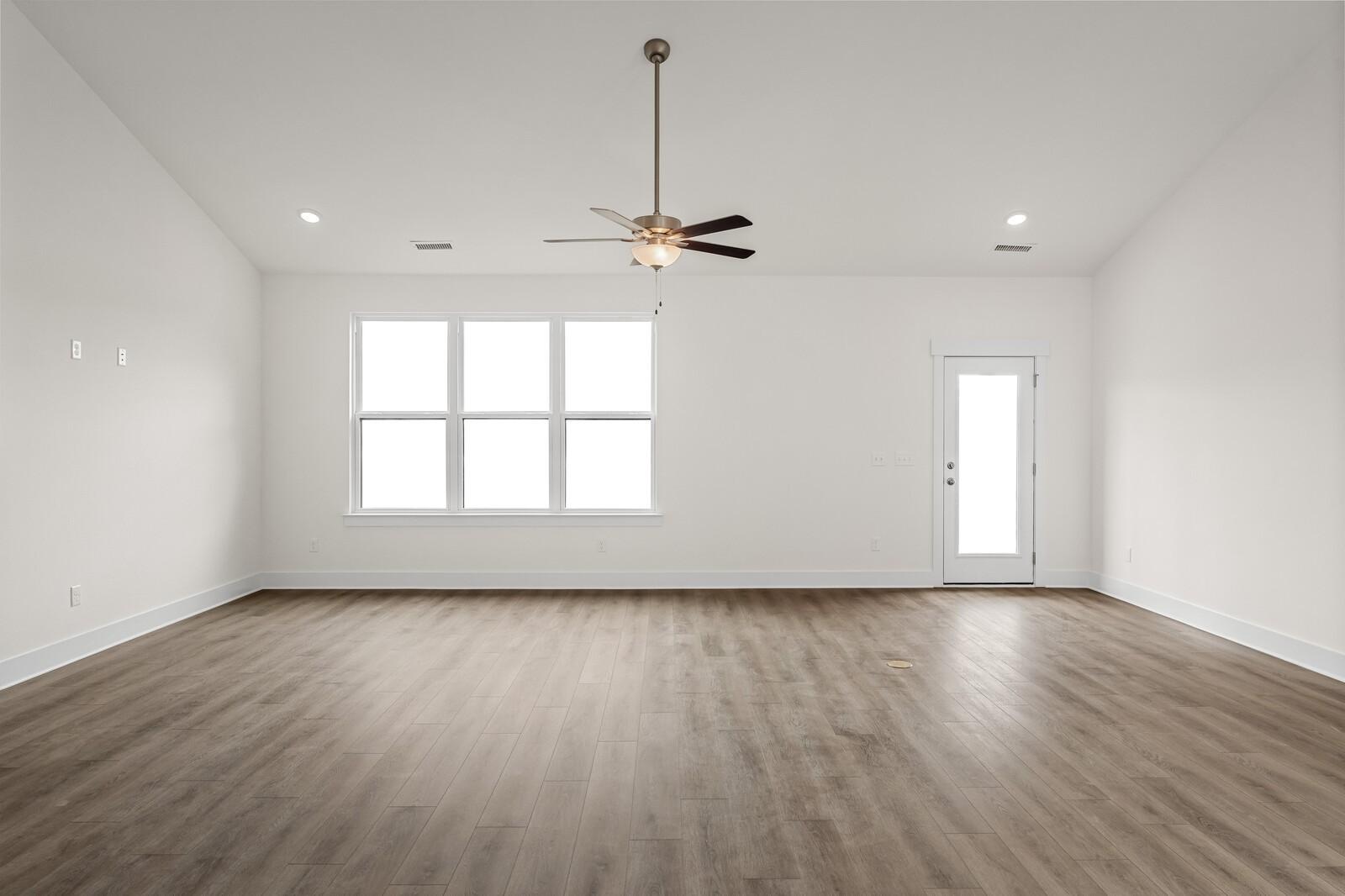 Spacious living room with vaulted ceiling and ceiling fan in The Ridgeport D floor plan, Benders Cove, Mt. Juliet, TN.