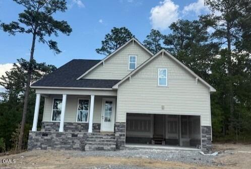 Two-story Birch II A model home by Davidson Homes with stone facade and two-car garage in Montrose, Aberdeen, NC.