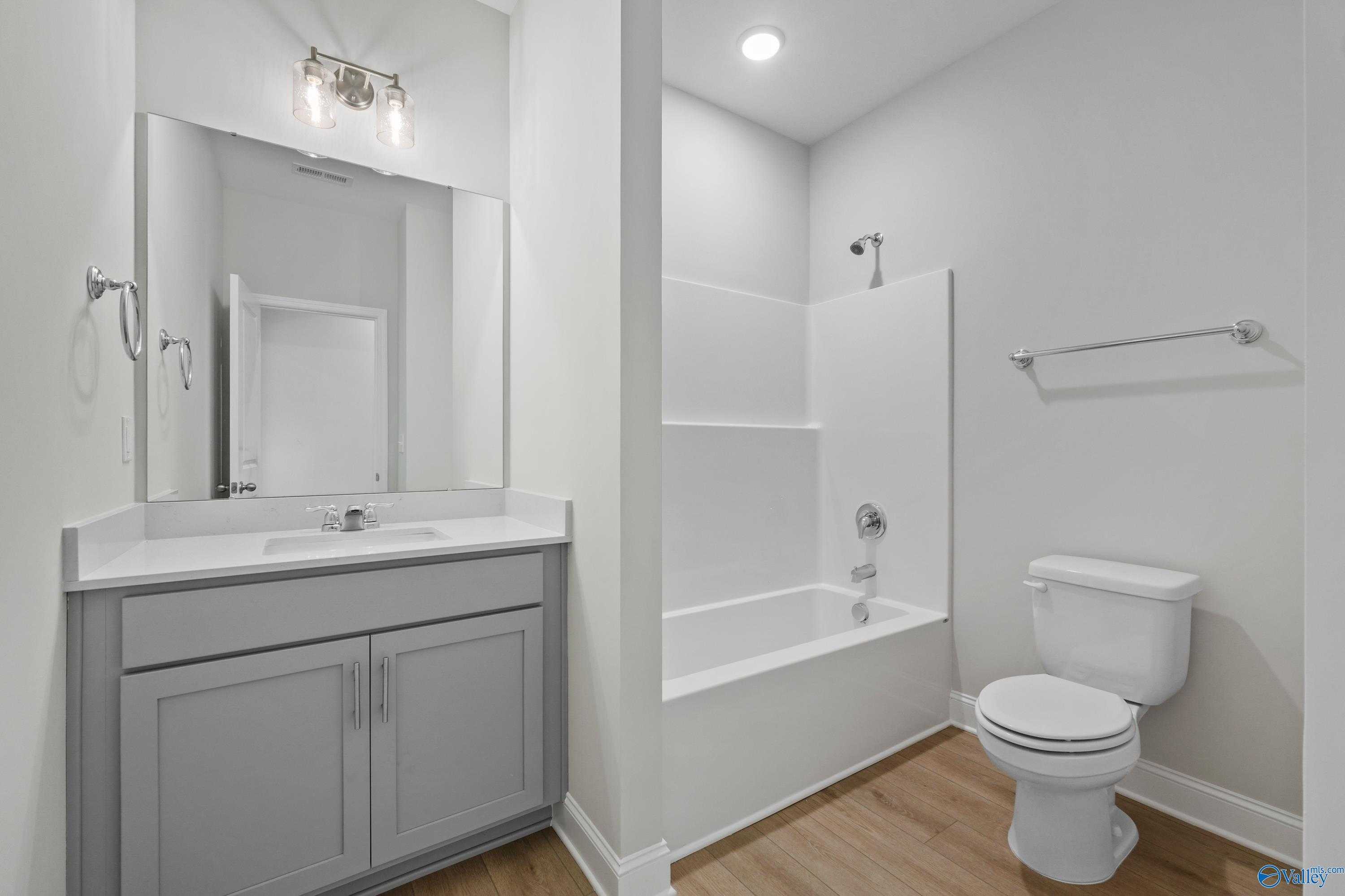 Spacious master bathroom with double gray vanity, soaking tub, glass shower in Davidson Homes The Everett, Hazel Green, AL