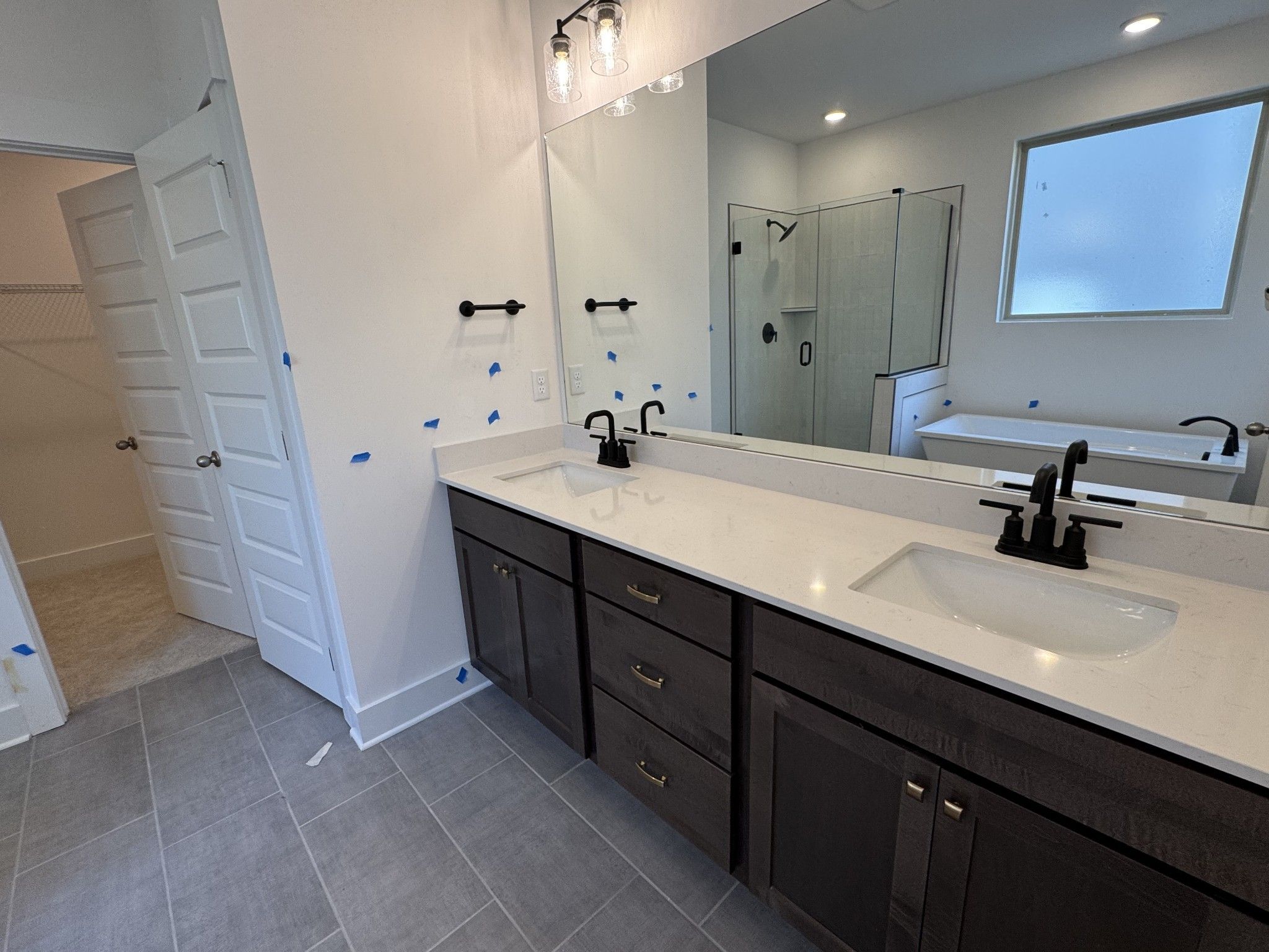 Modern master bathroom with double vanity, freestanding tub, and glass shower in Davidson Homes The Ridgeport C, Gallatin, TN