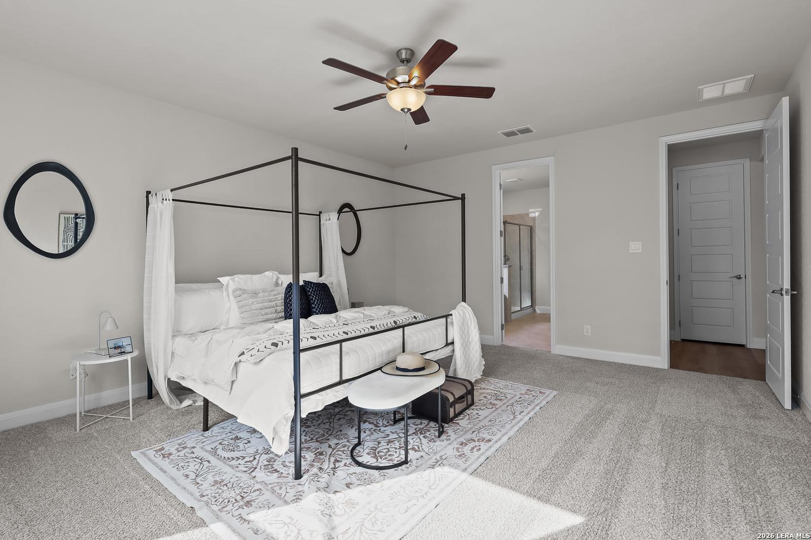 Spacious primary bedroom with canopy bed in The Lanier H floor plan by Davidson Homes in Ladera, San Antonio, Texas.