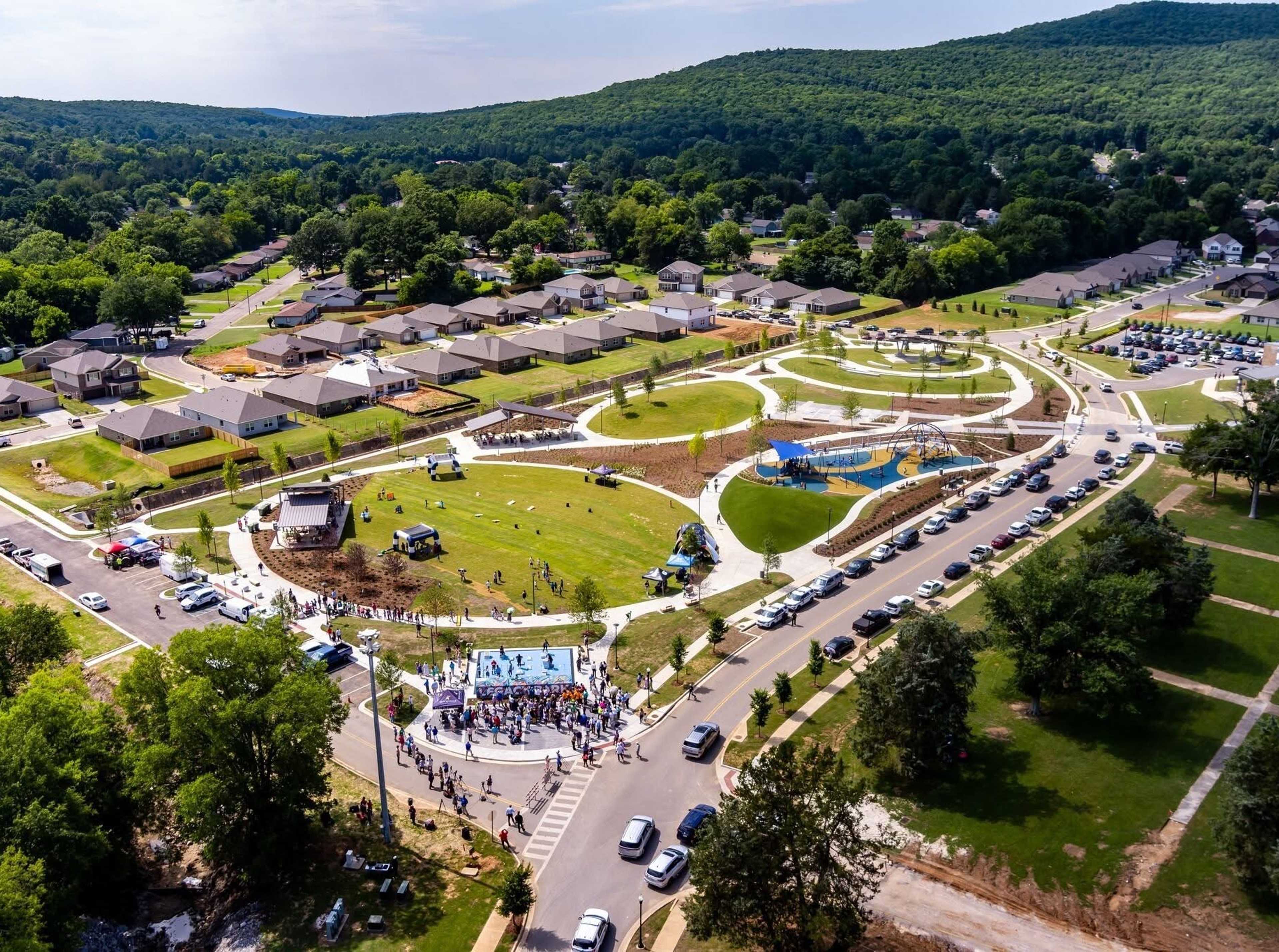 Vibrant playground at Jaguar Hills in Huntsville AL featuring colorful climbing nets, swings and sunny blue skies