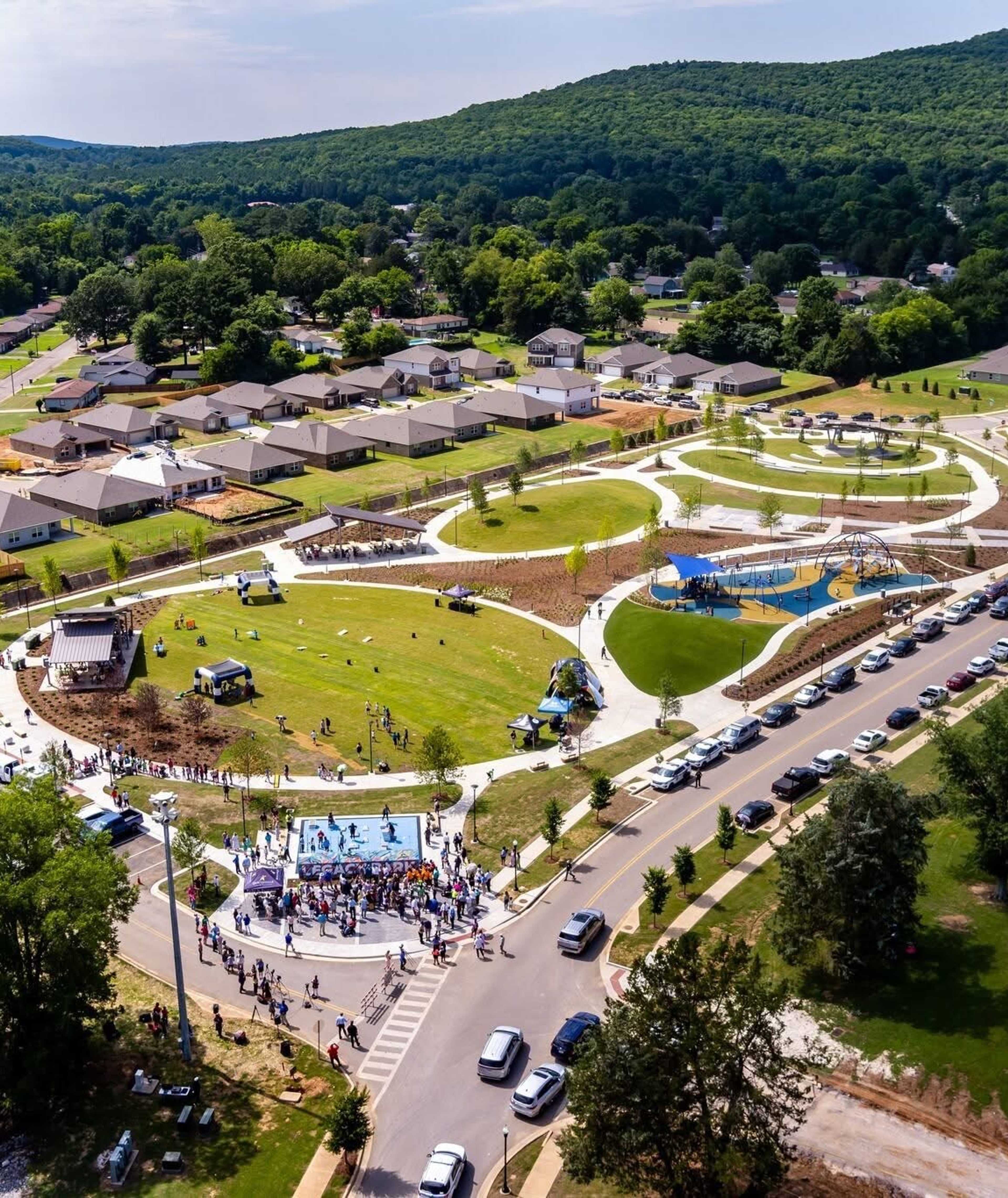 Vibrant playground at Jaguar Hills in Huntsville AL featuring colorful climbing nets, swings and sunny blue skies