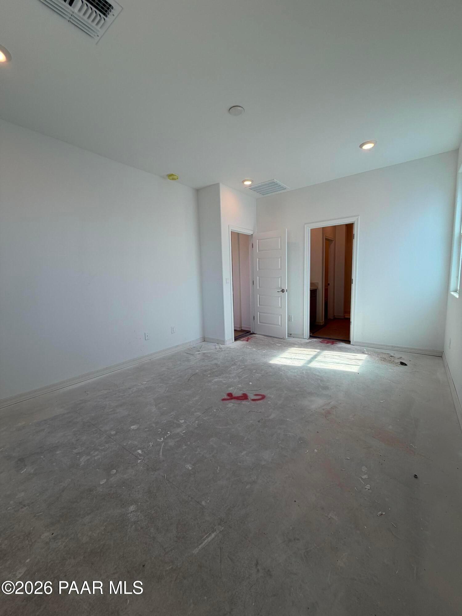 Unfinished bedroom with open concrete floor and natural light in Davidson Homes Marietta C plan, Prescott, Arizona