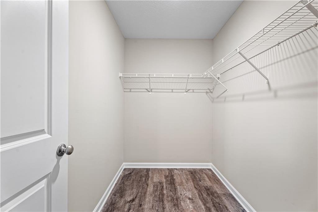 Spacious walk-in closet with wire shelving and hardwood floors in Davidson Homes The Washington, Phenix City, Alabama
