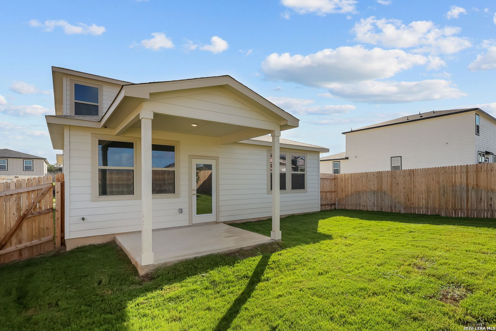 Covered back patio and fenced backyard of The Brazos B floor plan by Davidson Homes in Agave, San Antonio, Texas.