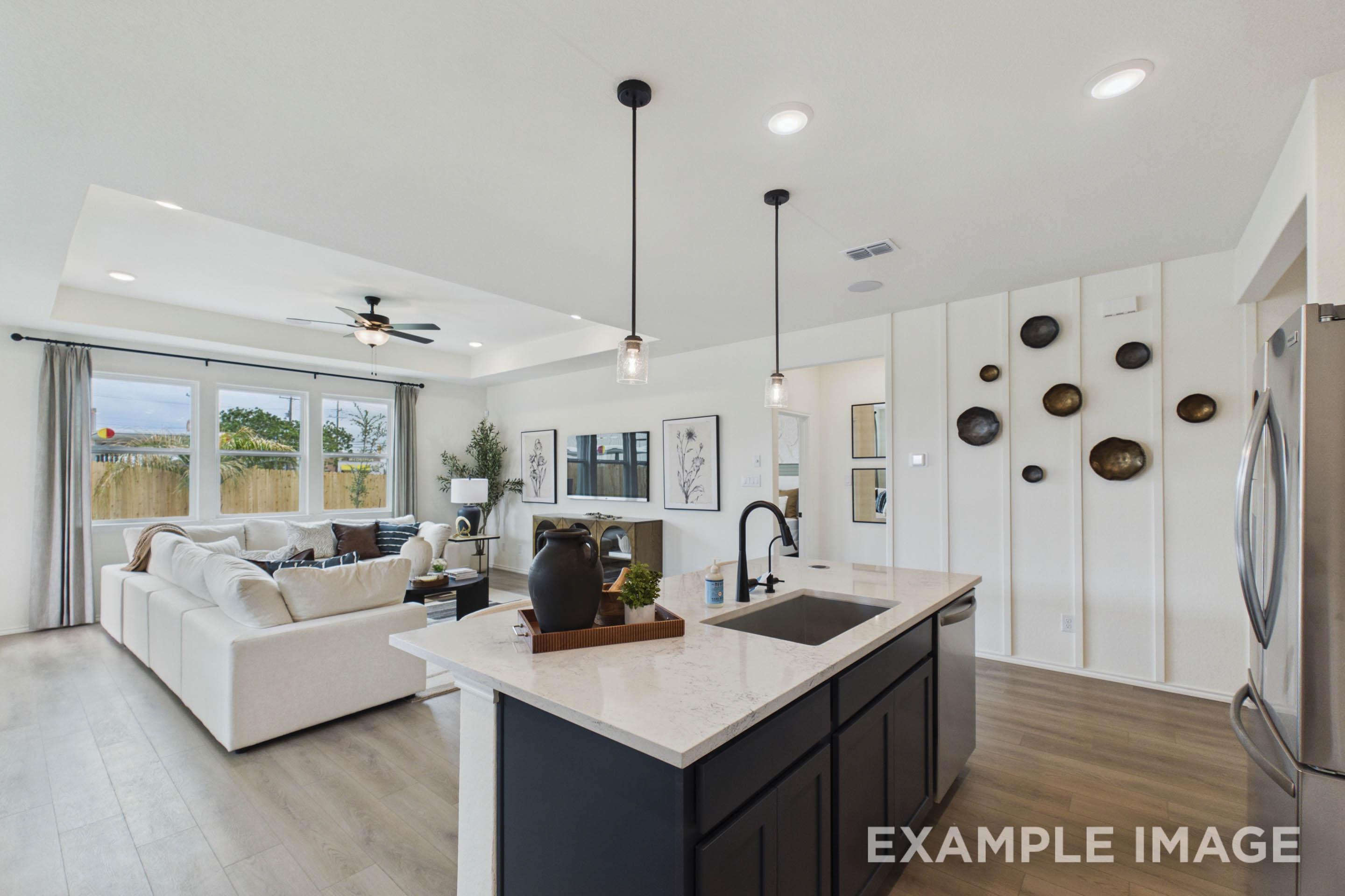 Open-concept living space in The Laurel G featuring a modern kitchen island and spacious great room in San Antonio.