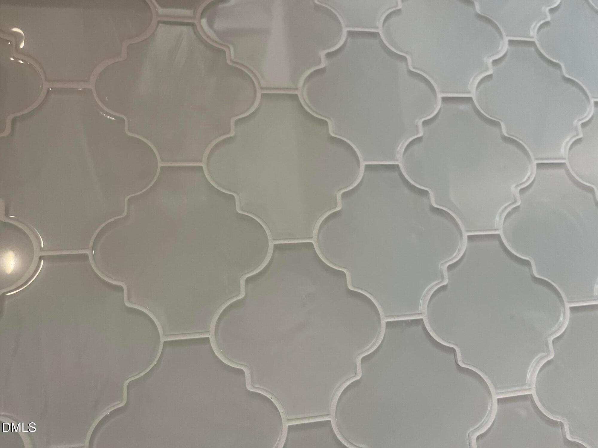 Elegant white arabesque glass tile backsplash in primary bathroom, The Ashport G by Davidson Homes, Wake Forest, NC