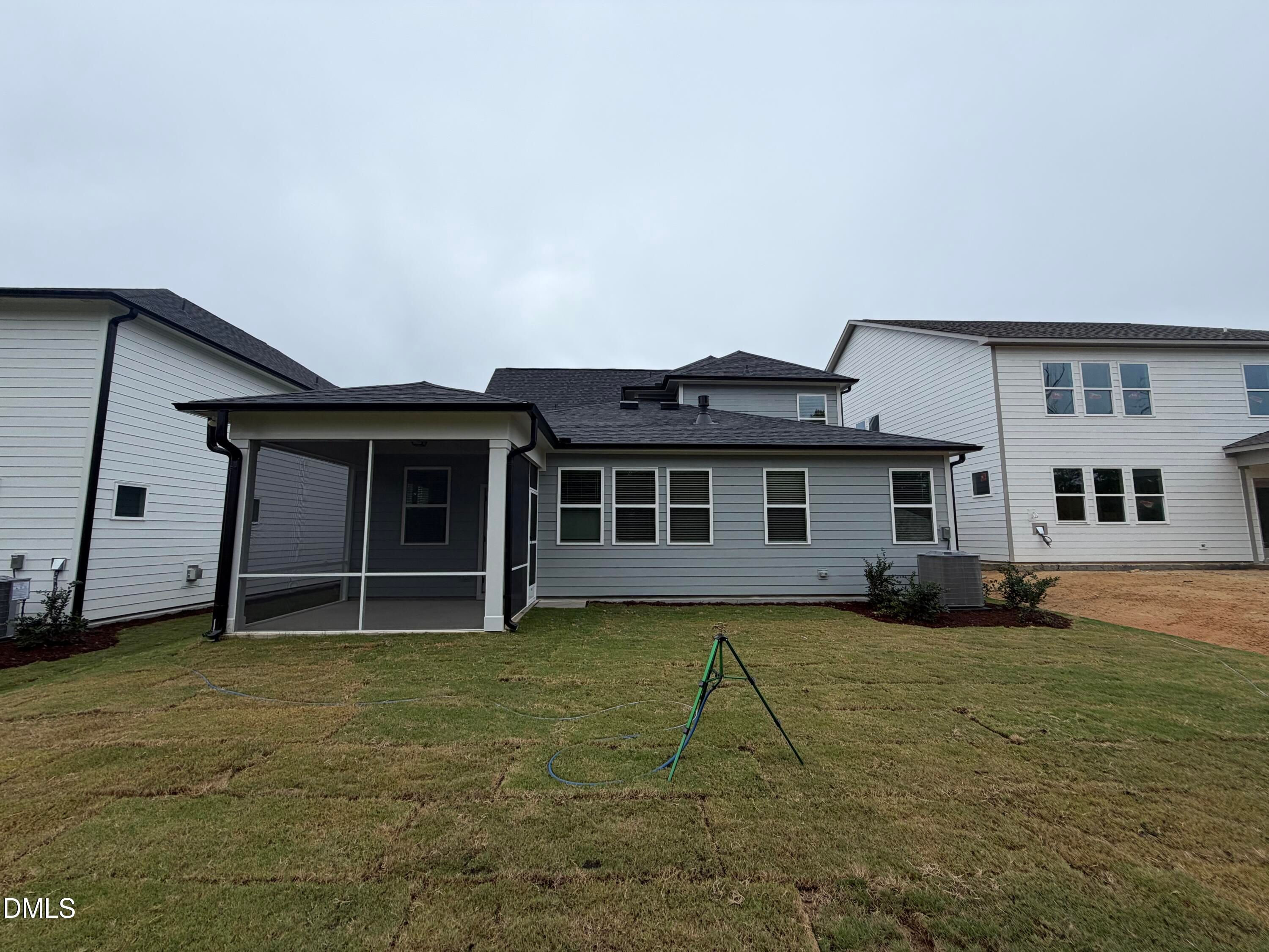 Rear exterior of Davidson Homes' The Ashport M with screened porch and fenced backyard in Wendell Ridge, Wendell, North Carolina