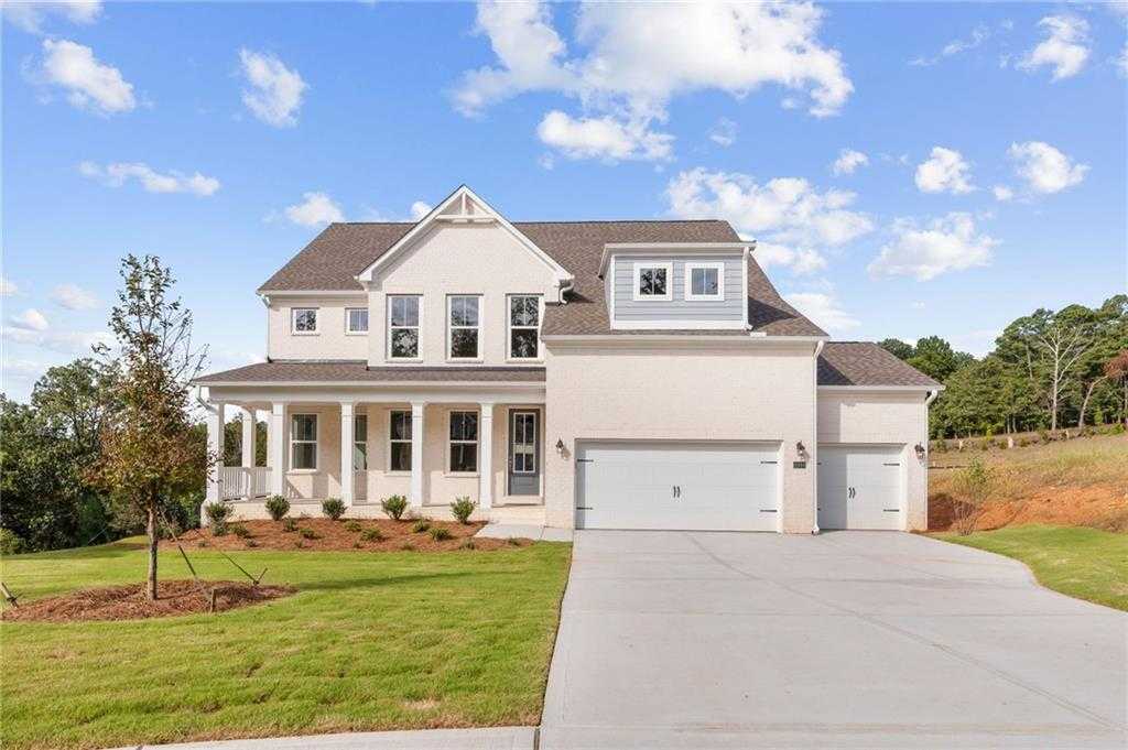 Two-story 4-bedroom home with wrap-around porch, 3-car garage, and landscaped yard in Melody Lakeside Estates, Buford, Georgia